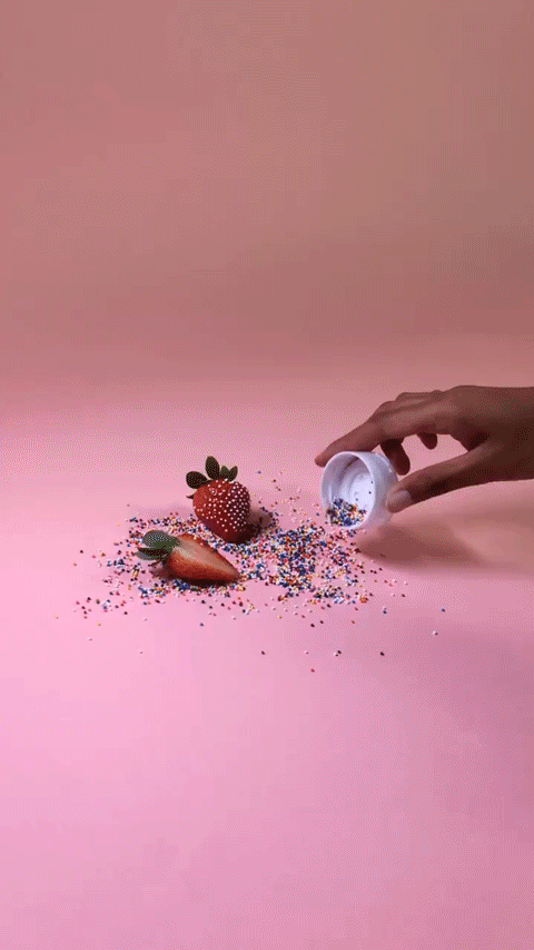 pouring sprinkles around trial strawberry