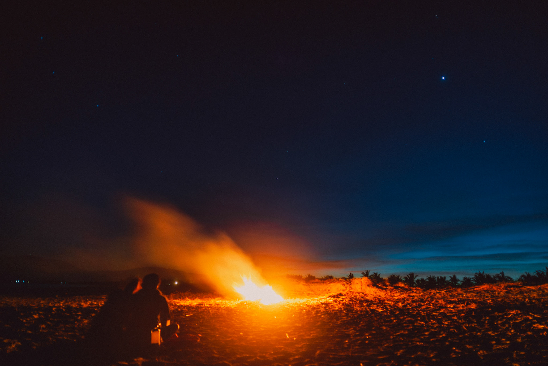 Couple portraits beside a bonfire moments before sunrise, from Koke and Pam's chill and outdoorsy prenup photoshoot in Bonuan Beach, Dagupan, Pangasinan, Philippines, Southeast Asia, November 2015, Sony A7S.