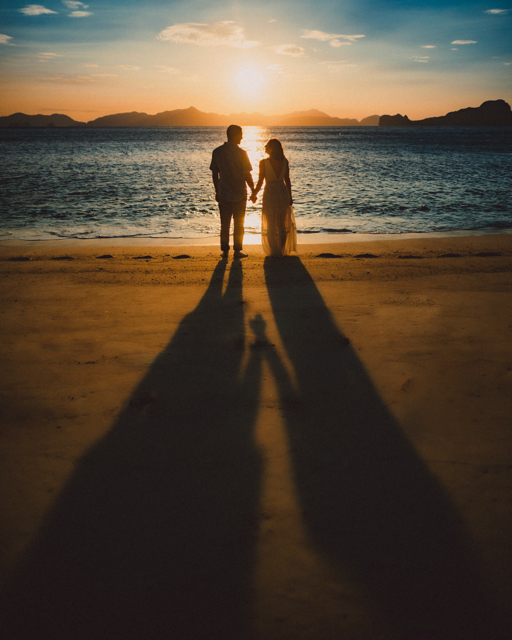 Long tall shadows of a couple holding hands before sunset, from Peter &amp; Alexis' adventure engagement in El Nido, Palawan, Philippines, Southeast Asia, April 2018, Sony A7SII