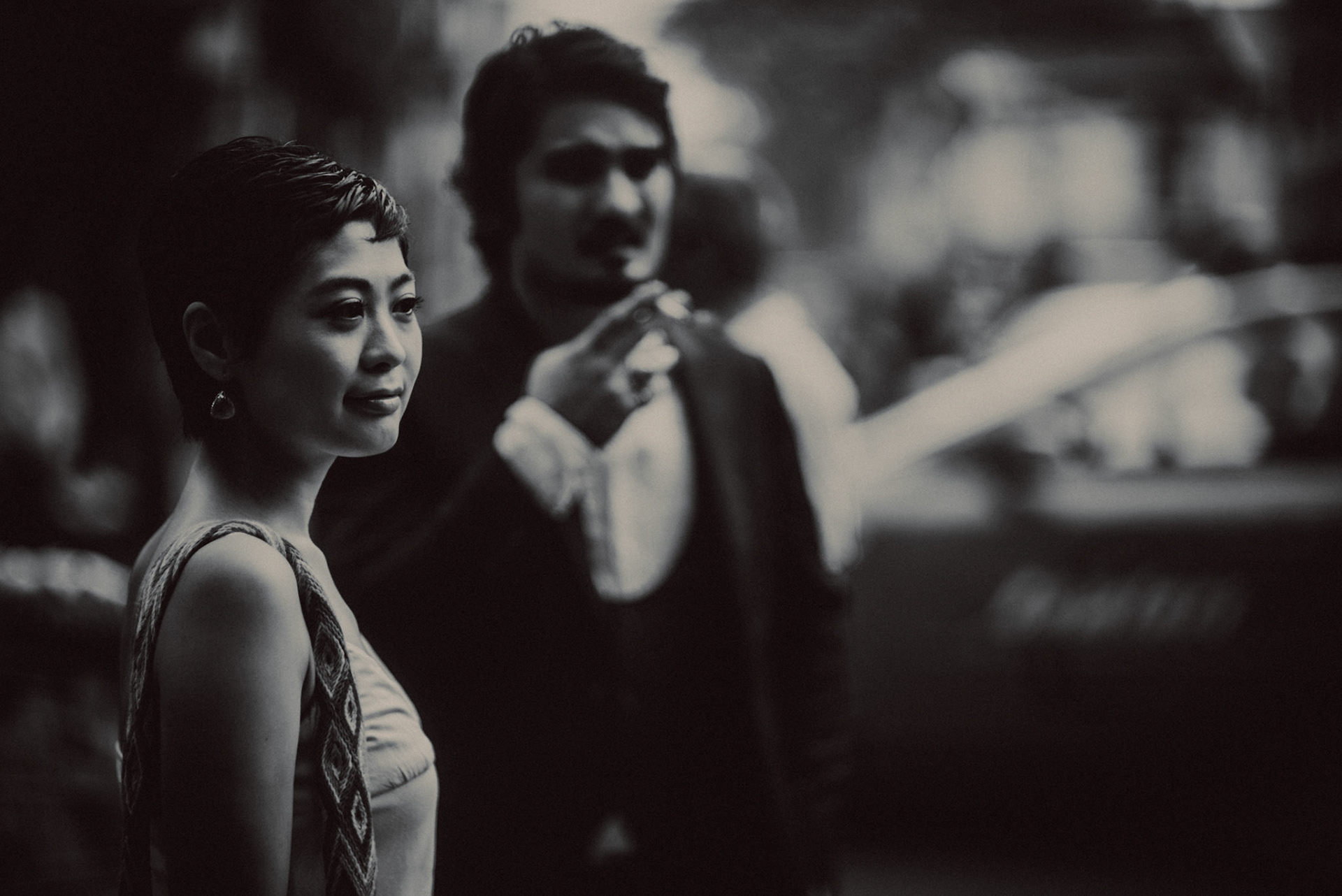 A candid, reportage-style engagement shoot in Little India on a Sunday afternoon feauring a Japanese couple, in black and white, Farrer Park, Singapore, October 2015, Sony A7S.
