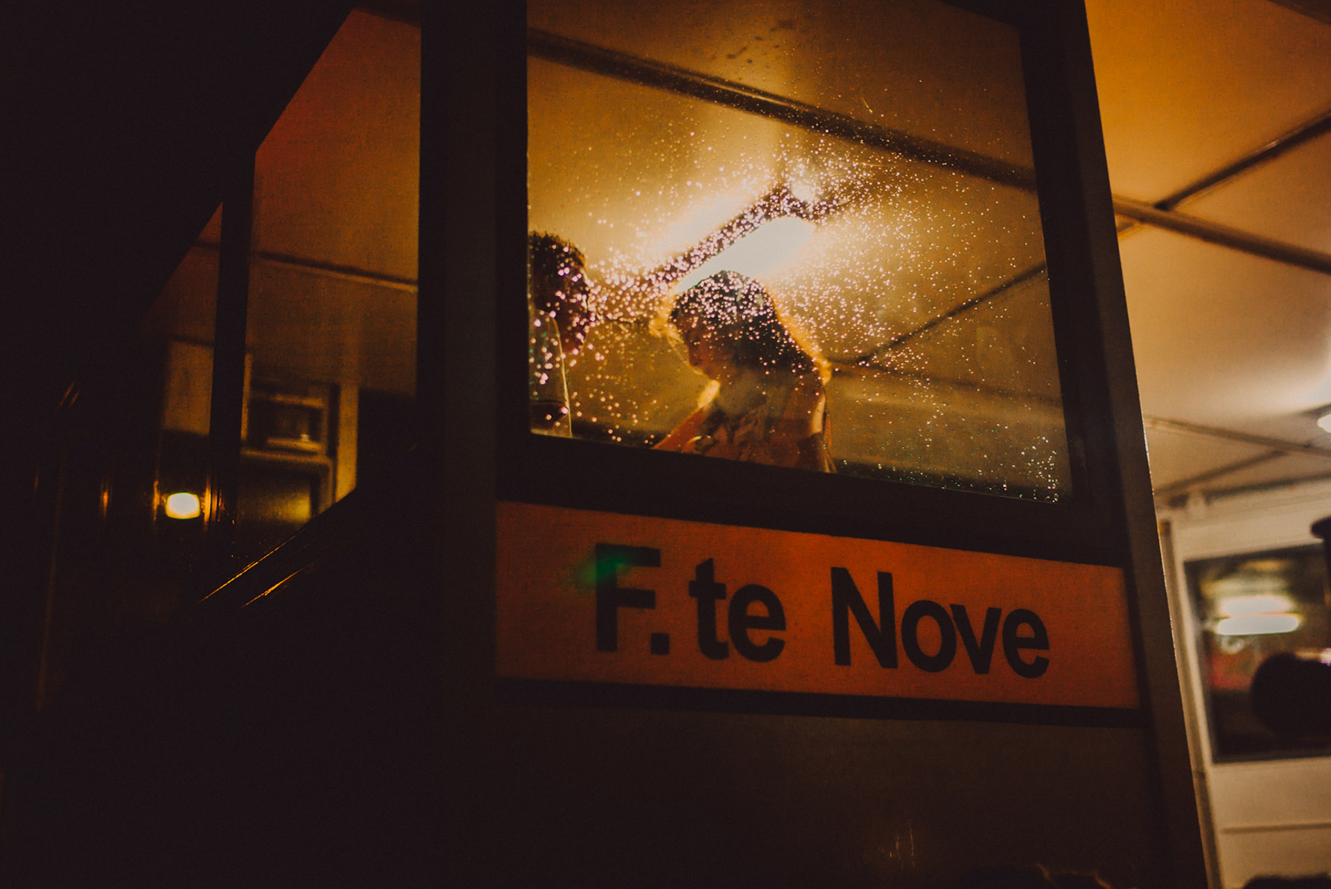 A couple at the F. te Nove water taxi station at night, Venice, Italy, July 2015, Leica M.