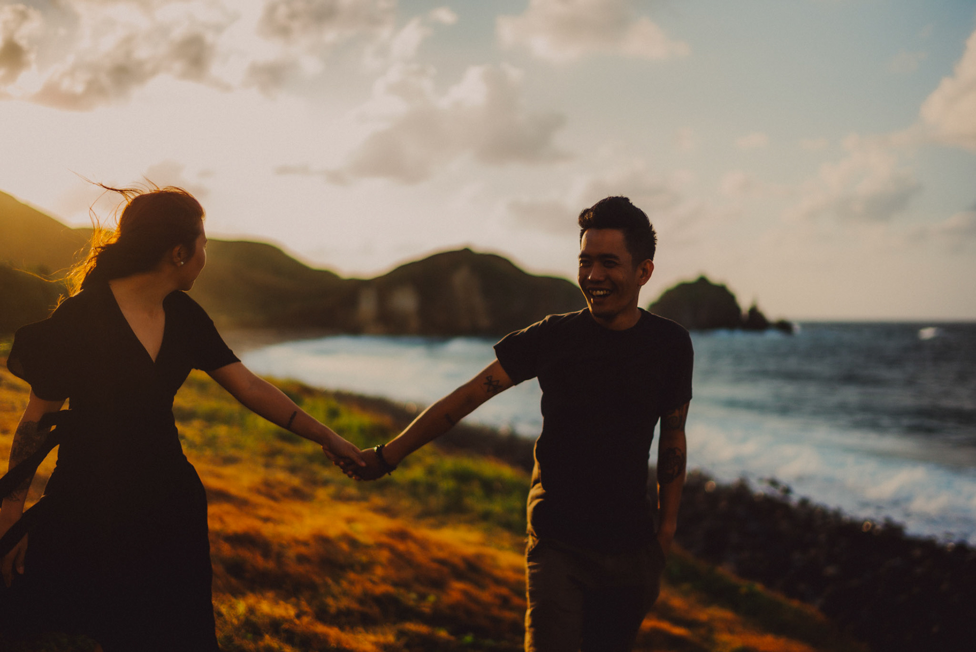 Cinematic sunset couple portraits on a seaside cliff, from Owen and Nikka's adventure prenup photoshoot in Chadpidan Boulder Beach, Batanes, Philippines, Southeast Asia, October 2017, Leica M.
