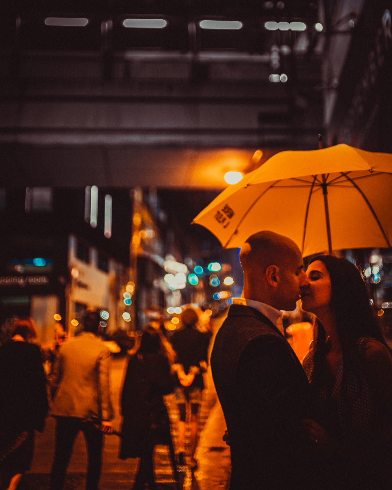 A moody and intimate late night urban engagement shoot with the couple under a bright yellow Merde Il Pleut umbrella, from Eric and Sabrina's prewedding shoot in Central, Hong Kong, April 2019, Sony A7III.