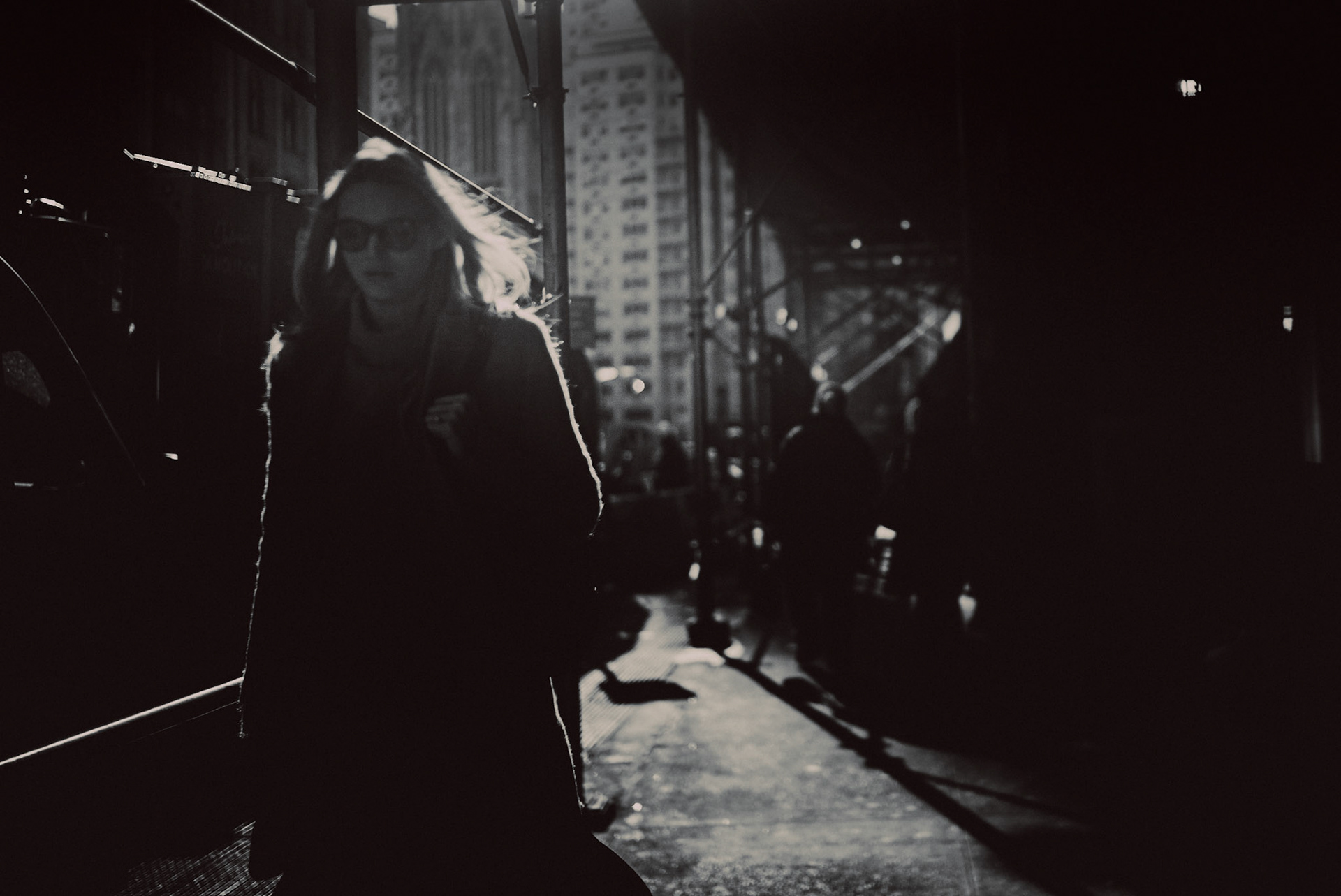 A woman in sunglasses walking along Broadway, Manhattan, New York City, USA, December 2017, Leica M.