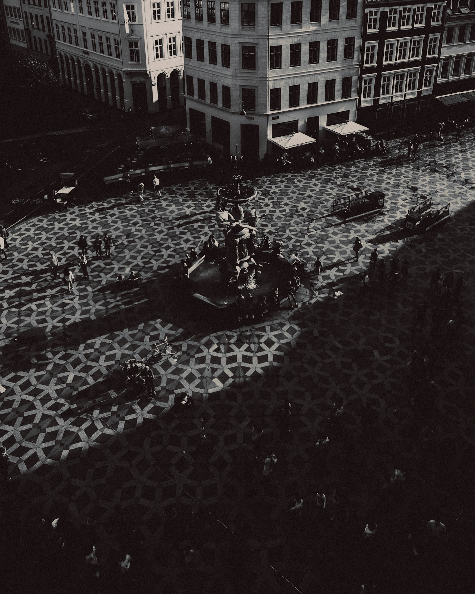 A high angle view of a shadowy fountain in Strøget, in black and white, Copenhagen, Denmark, July 2017, Huawei P10 Plus.