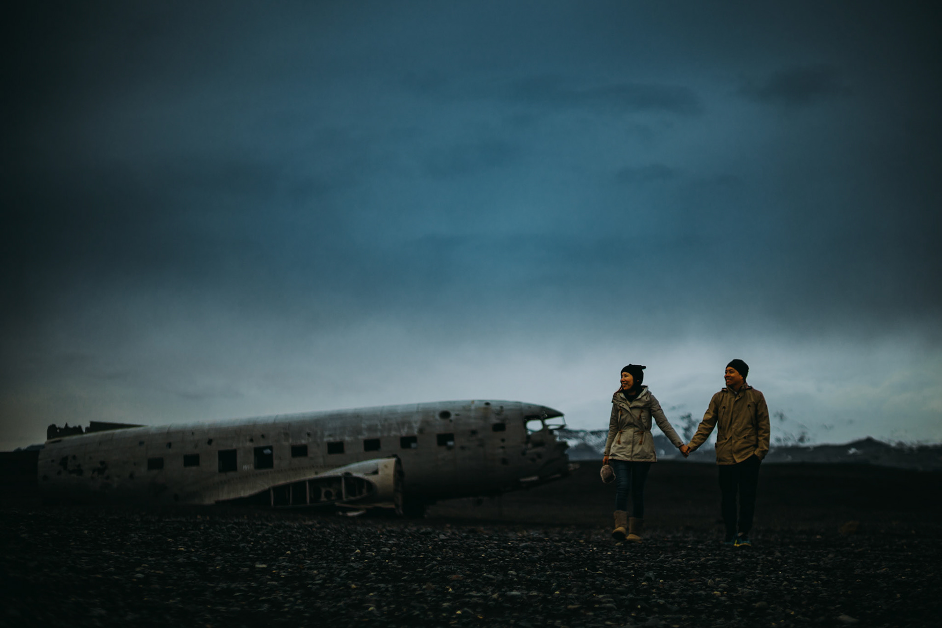 Moody-toned candid adventure engagement portraits at the Sólheimasandur Plane Crash Site, Iceland, May 2016, Sony A7RII.