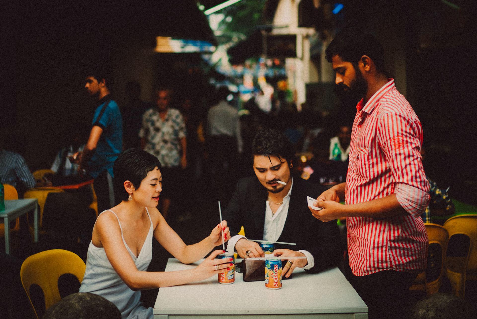A Japanese couple enjoying a Sunday afternoon in an Indian food stall near Mustafa Centre, from Ibuki and Emi's candid chill engagement shoot in Little India, Singapore, October 2015, Sony A7S.