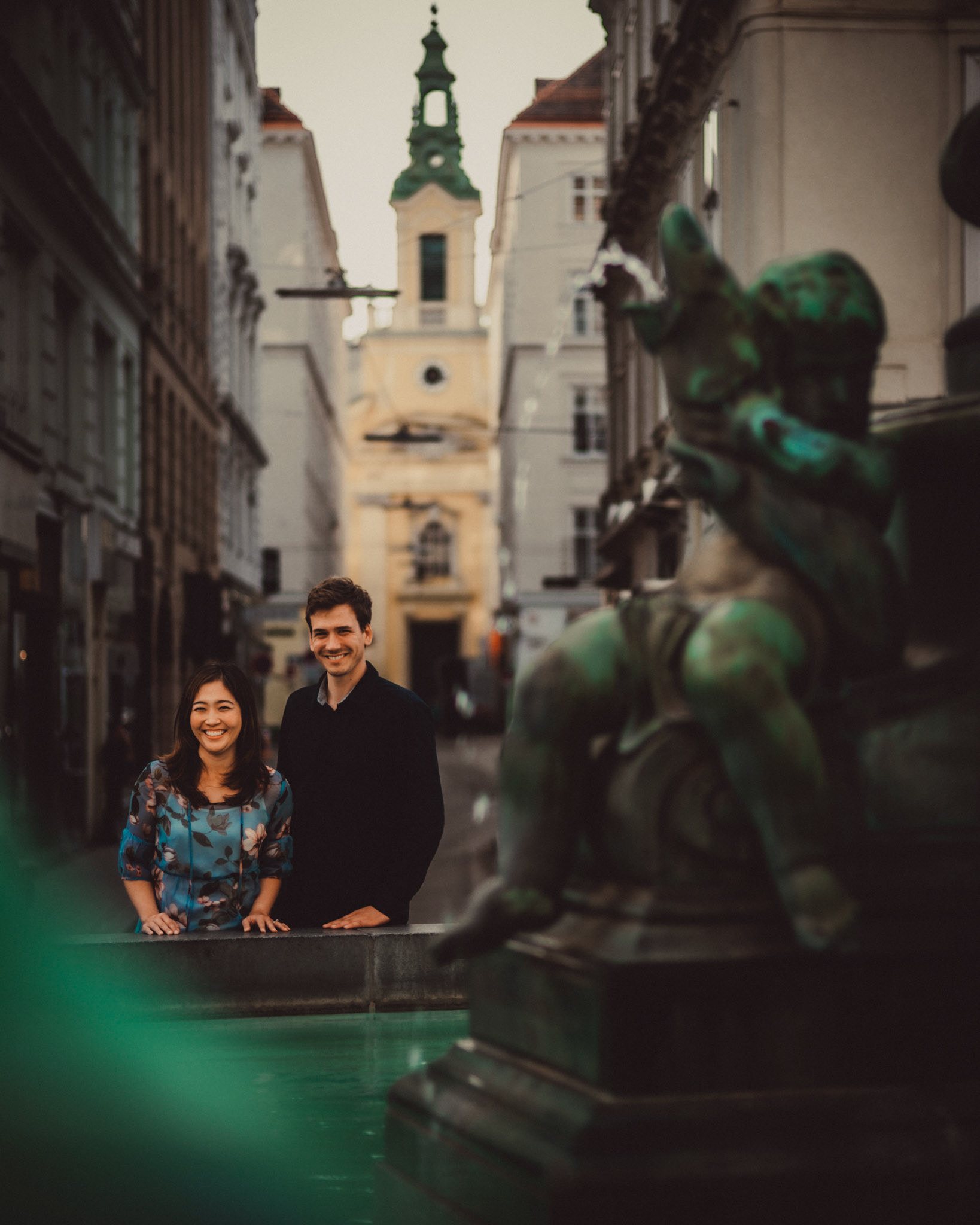 Casual and filmic destination engagement photos inspired by "Before Sunrise" movie locations, Donnerbrunnen fountain at Neuer Markt Square, Innere Stadt, Vienna, Austria, August 2017, Leica M.