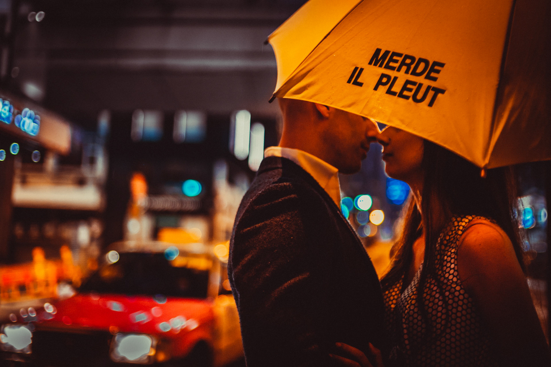 A moody and intimate late night urban engagement shoot with the couple under a bright yellow Merde Il Pleut umbrella, from Eric and Sabrina's prewedding shoot in Central, Hong Kong, April 2019, Sony A7III.