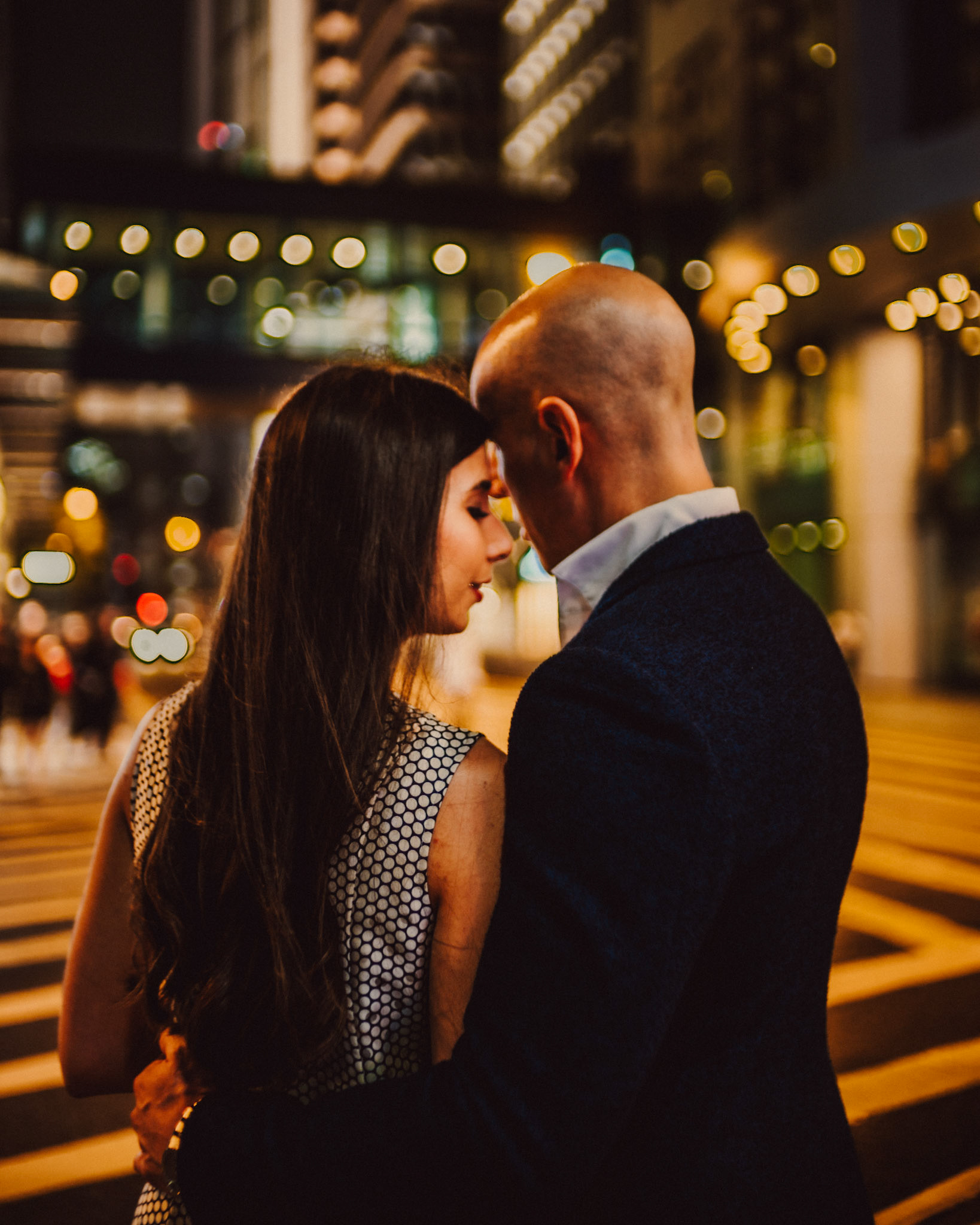 Night city couple portraits in bustling Queen's Road, from Eric and Sabrina's engagement session in Central, Hong Kong, April 2019, Sony A7III.