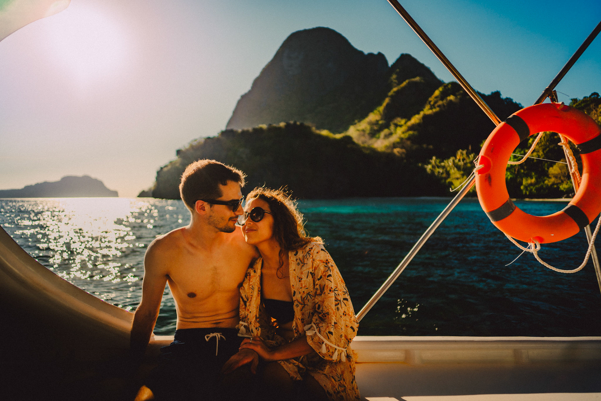 Travel couple portraits on a speed boat during an island hopping tour in Bacuit Bay, with Cadlao Island in the background, El Nido, Palawan, Philippines, Southeast Asia, April 2019, Sony A7III.