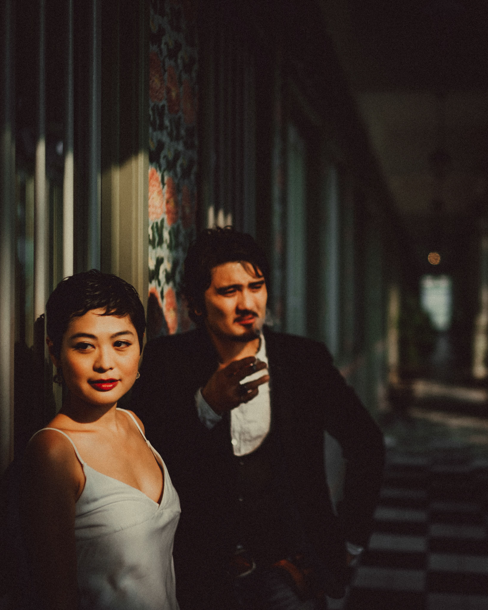 A Japanese couple sharing a lighthearted moment in a sunlit corridor with Peranakan details, from Ibuki and Emi's artsy moody engagement shoot, Pertain Road, Little India, Singapore, October 2015, Sony A7S.