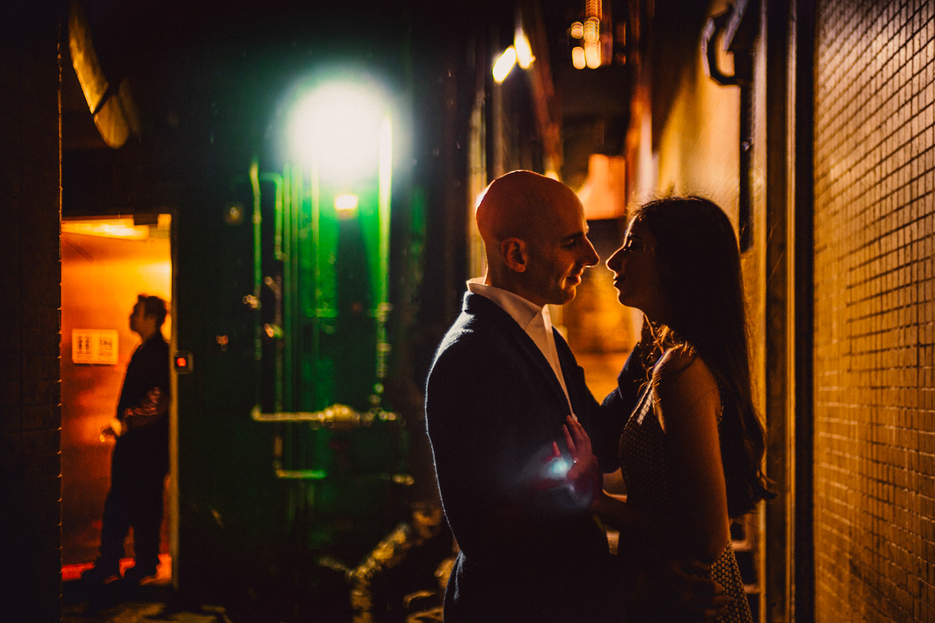 A moody and intimate late night urban engagement shoot with an incidental bystander in a prominently green alleyway in Stanley Street, from Eric and Sabrina's prewedding shoot in Central, Hong Kong, April 2019, Sony A7III.