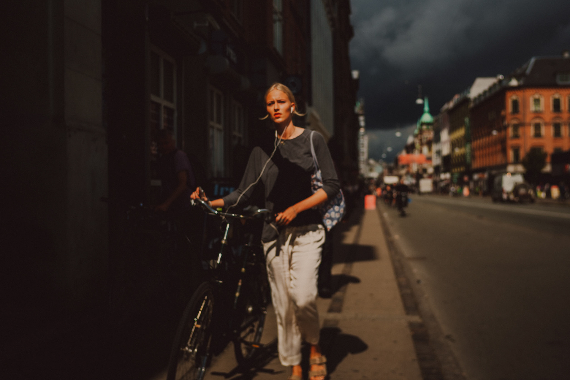 A woman walking her bike in Nørrebro, Copenhagen, Denmark, July 2017, Leica M.