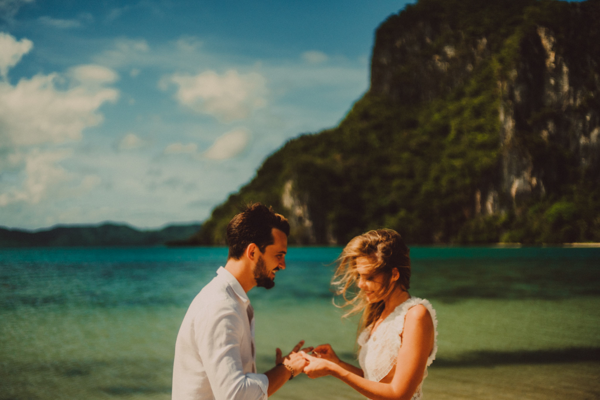 Wearing of wedding rings in Lagen Island's sandbar on a bright and sunny morning, El Nido, Palawan, Philippines, Southeast Asia, December 2019, Sony A7III.