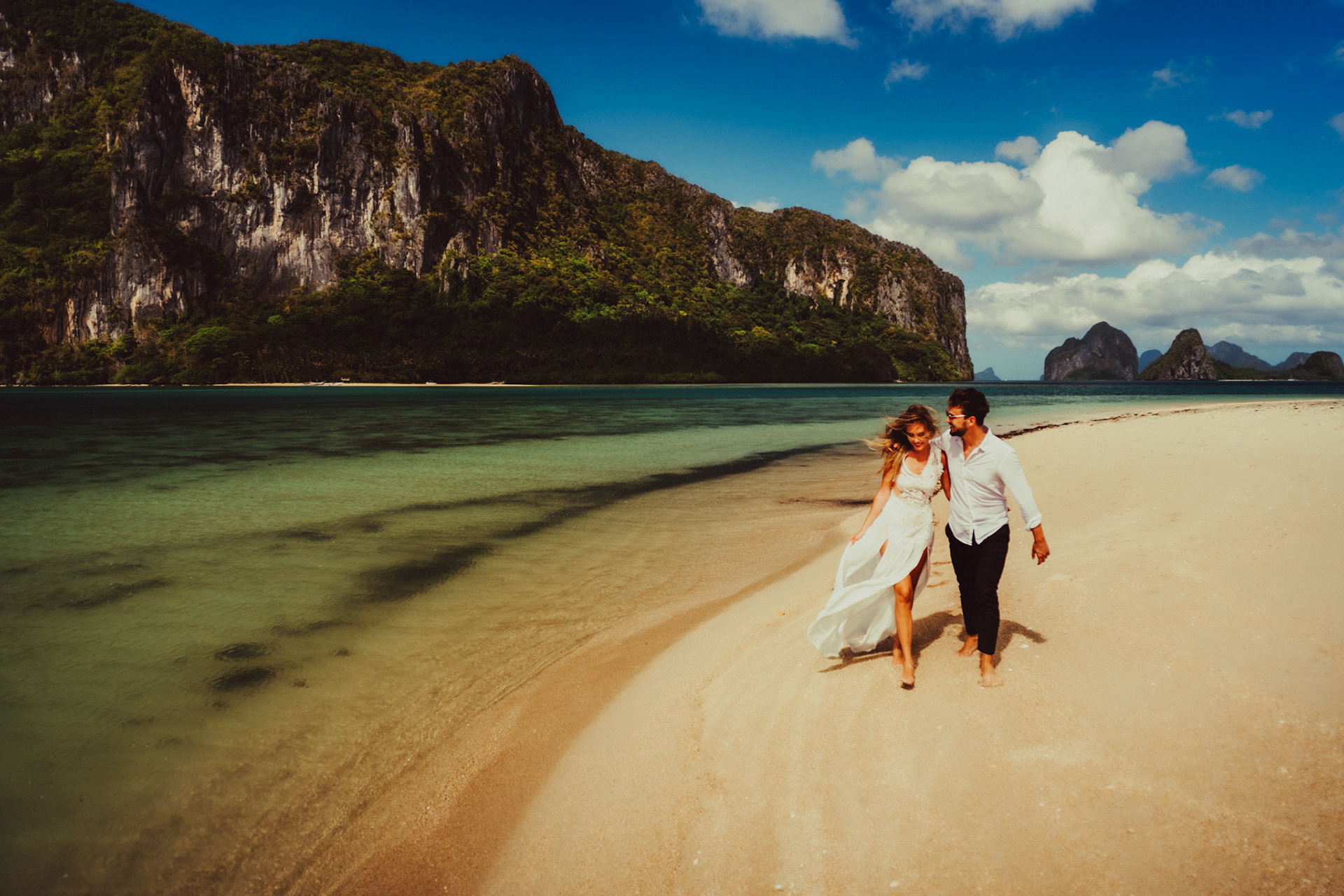 A honeymoon couple shoot in Lagen Island's sandbar on a bright and sunny morning, El Nido, Palawan, Philippines, Southeast Asia, December 2019, Sony A7III.