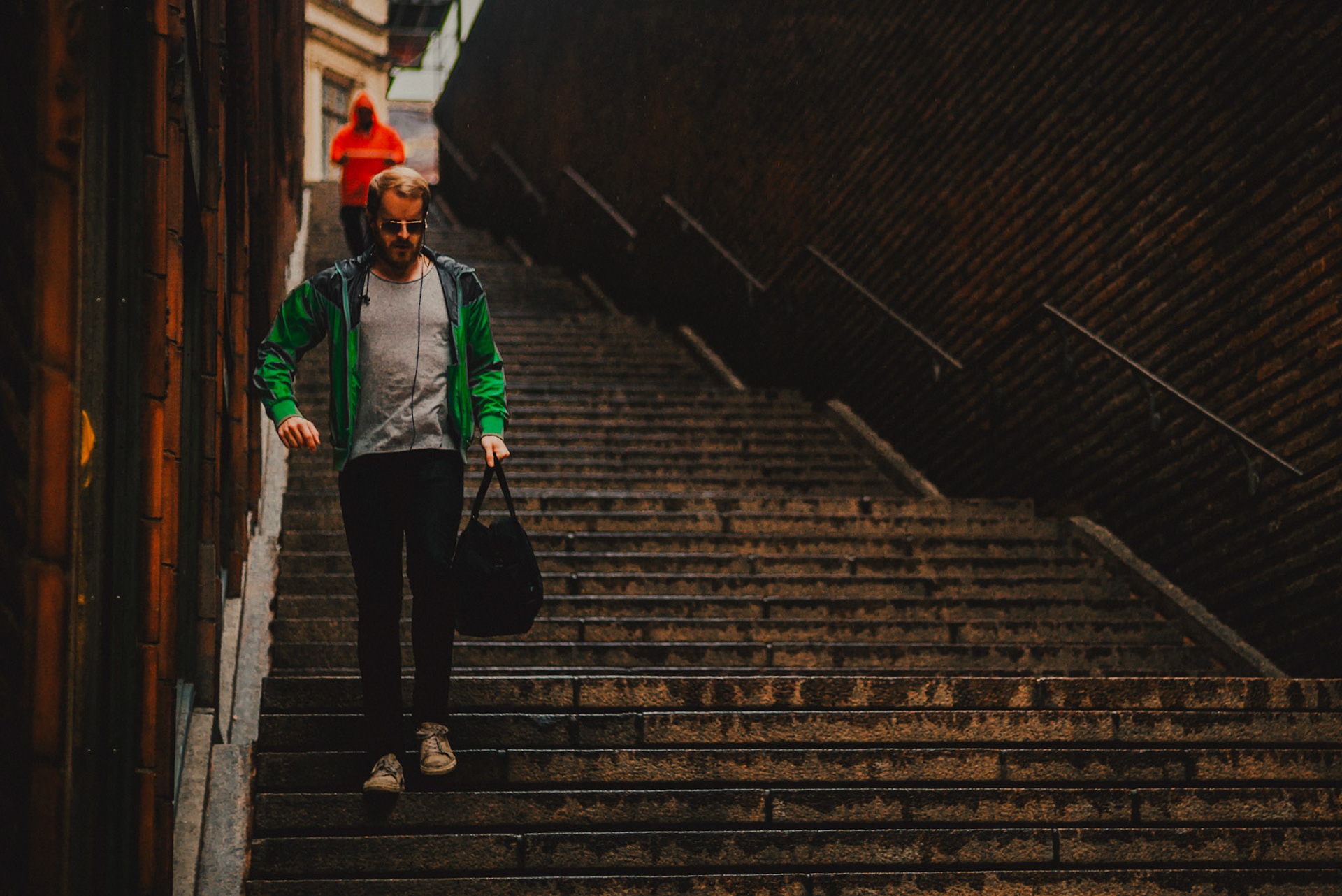 A Swedish man in a green jacket going down the Malmskillnadstrappan bridge stairs, Stockholm, Sweden, July 2016, Leica M.