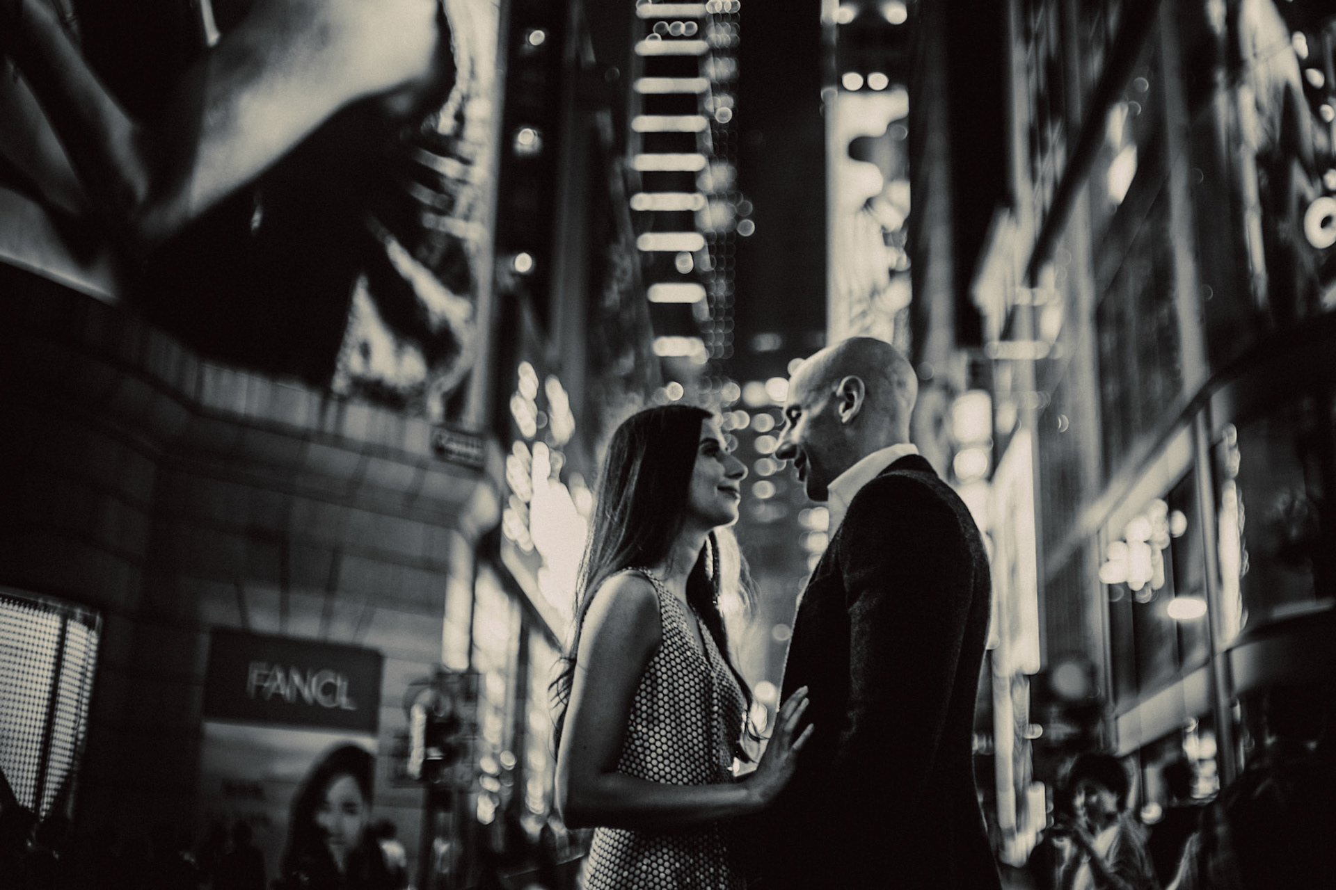 Night city couple portraits in bustling Queen's Road, from Eric and Sabrina's engagement session in Central, Hong Kong, April 2019, Sony A7III.