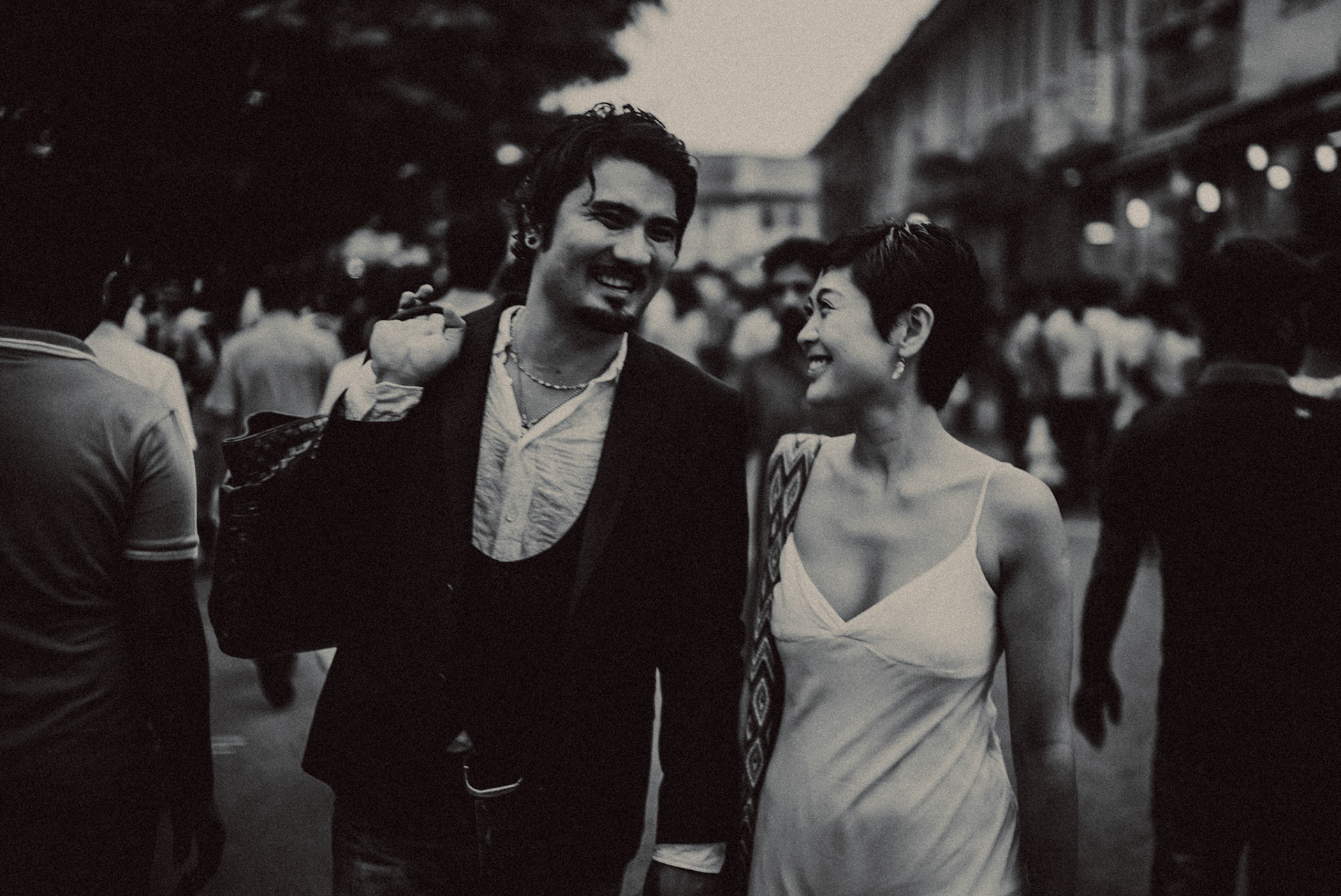 A candid, reportage-style engagement shoot in Little India on a Sunday afternoon feauring a Japanese couple, in black and white, Farrer Park, Singapore, October 2015, Sony A7S.