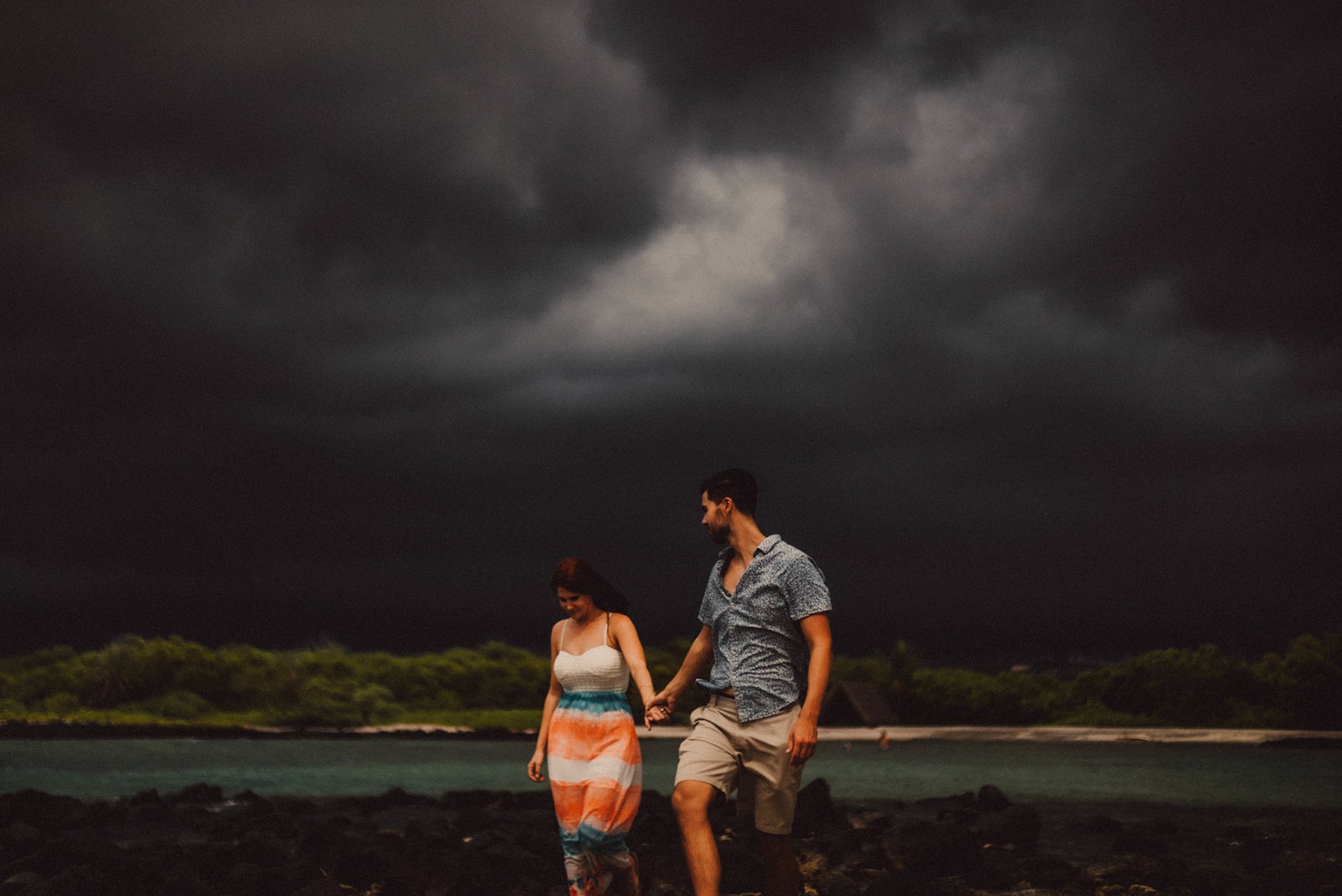 Stormy weather engagement portraits at Honokohau Beach, from Ryan and Angela's adventure pre wedding photoshoot in Hawaii, USA, September 2015, Sony A7S.