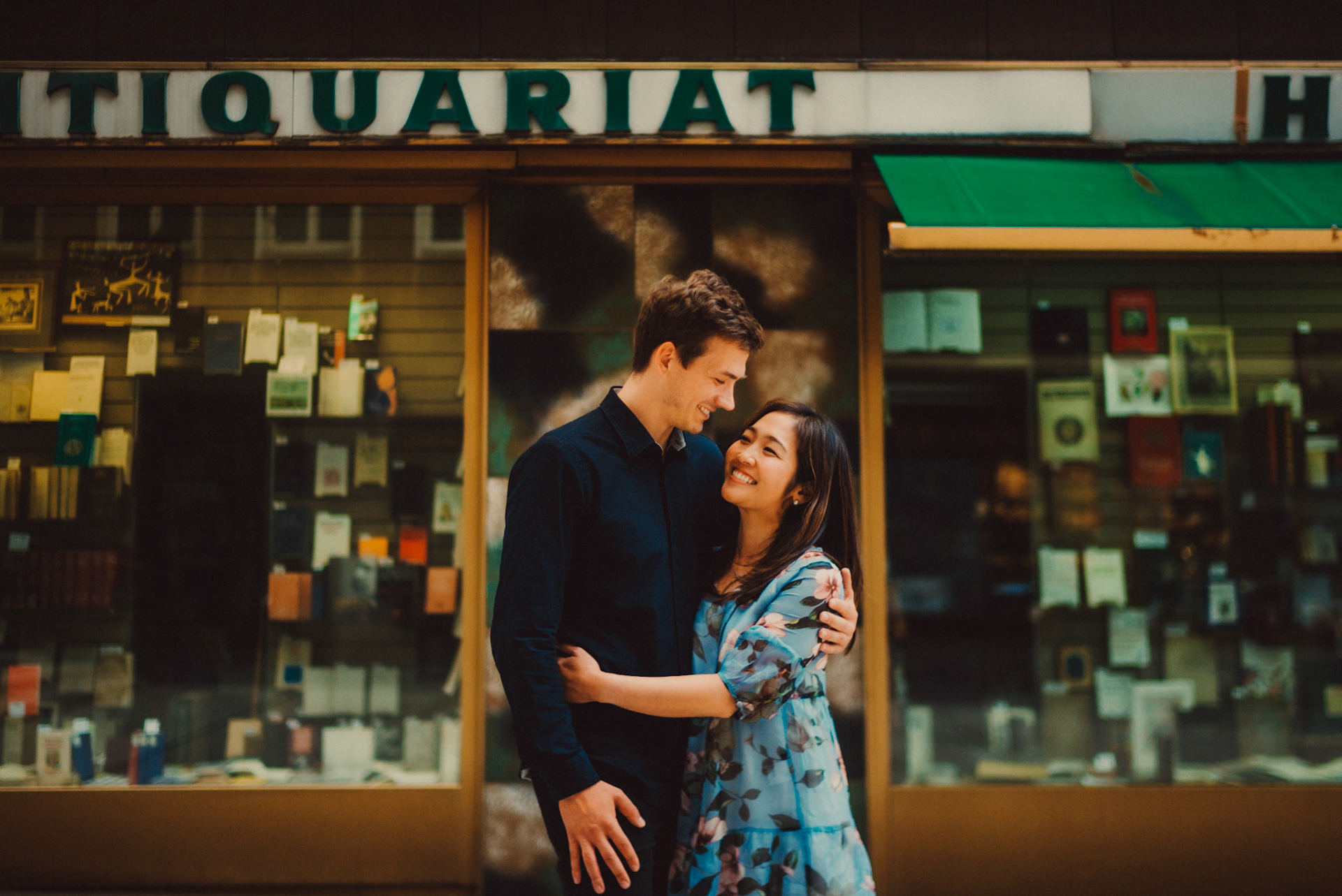 The couple standing in front of a quaint Austrian book shop, Innere Stadt, Vienna, Austria, August 2017, Leica M.