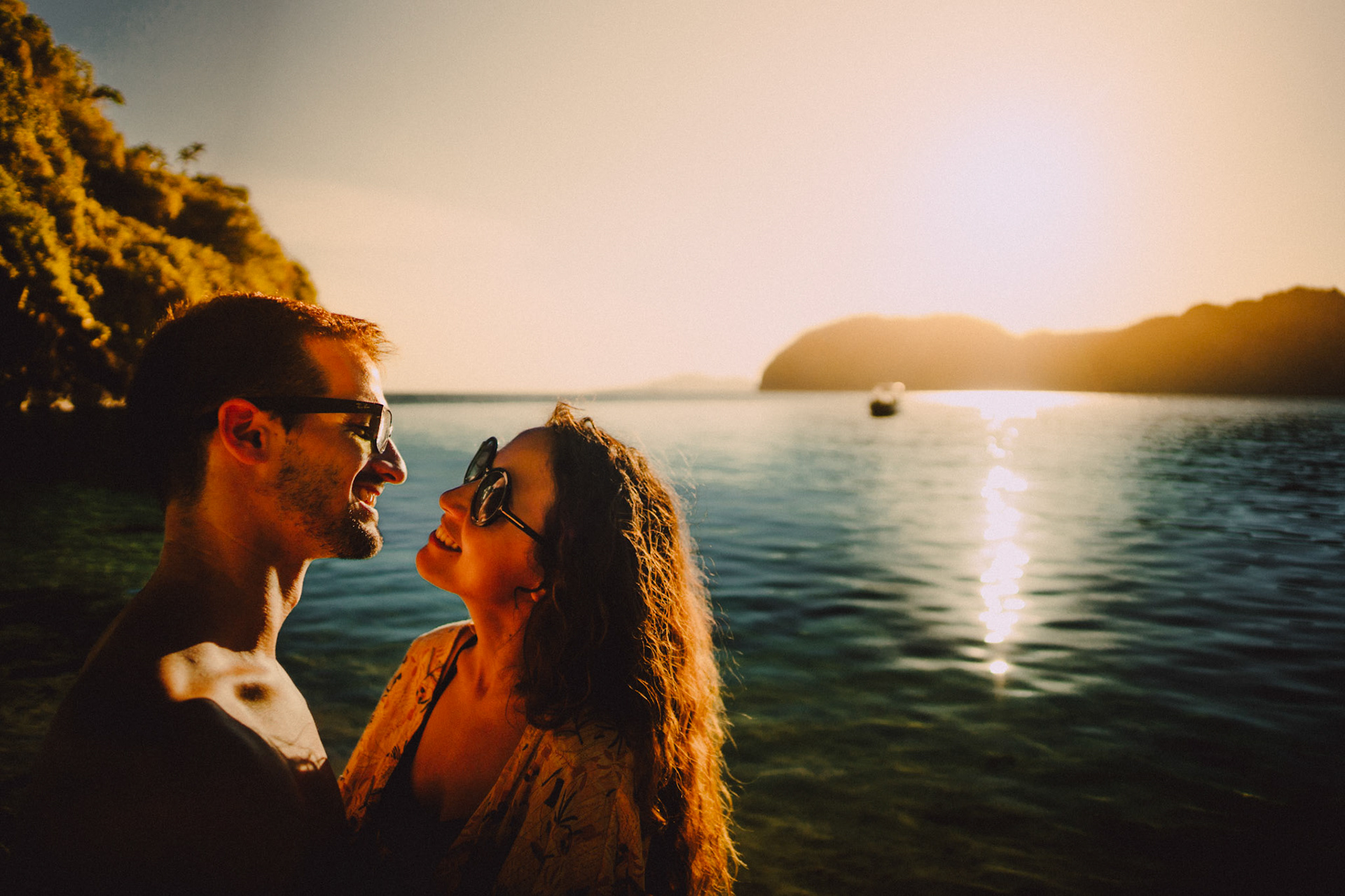 Cozy couple portraits in Entalula Island's secluded west-facing beach just moments before sunset, El Nido, Palawan, Philippines, Southeast Asia, April 2019, Sony A7III.
