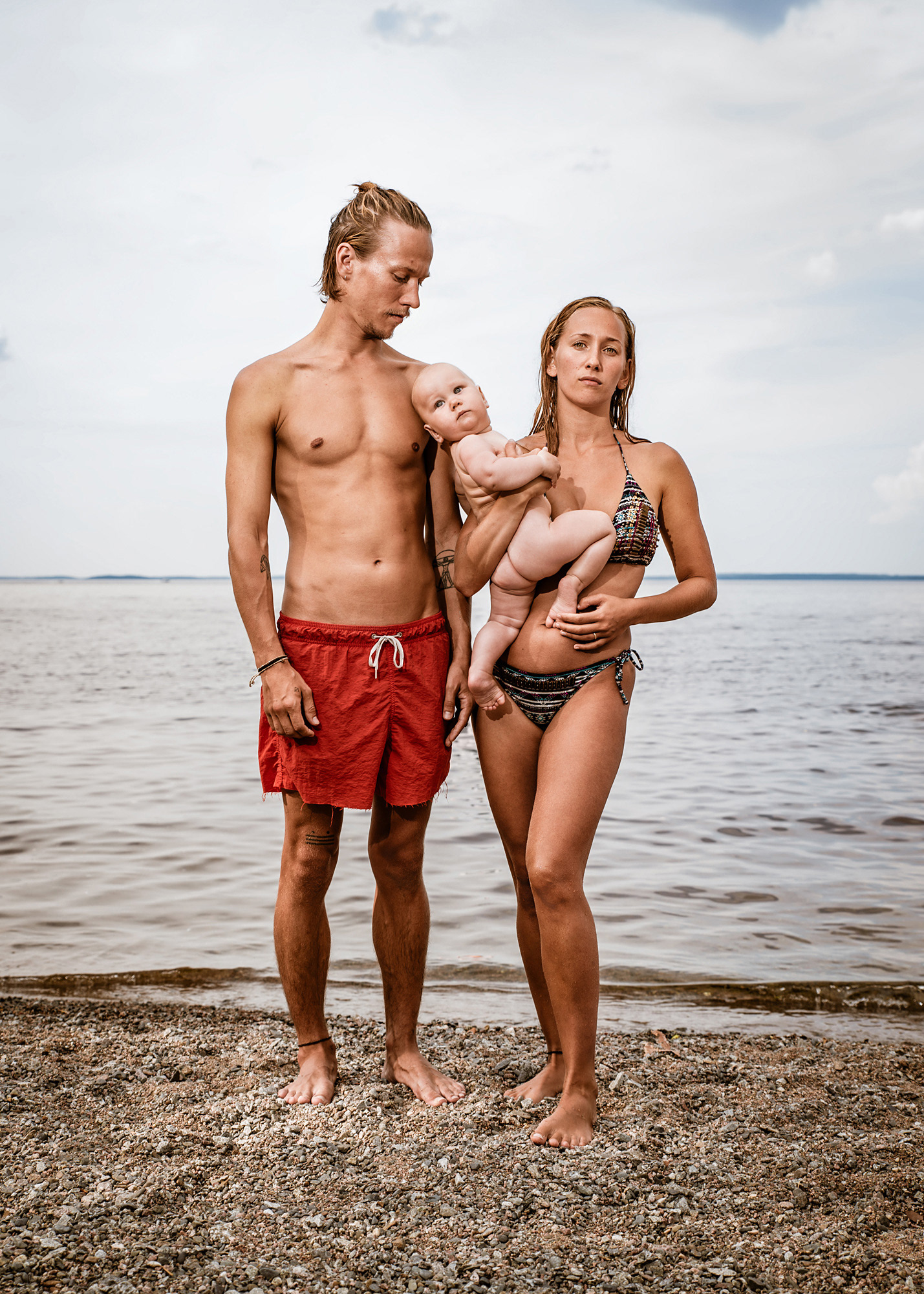 A family portrait from the photo series People Things and Objects at the Beach by Tommi Taipalus