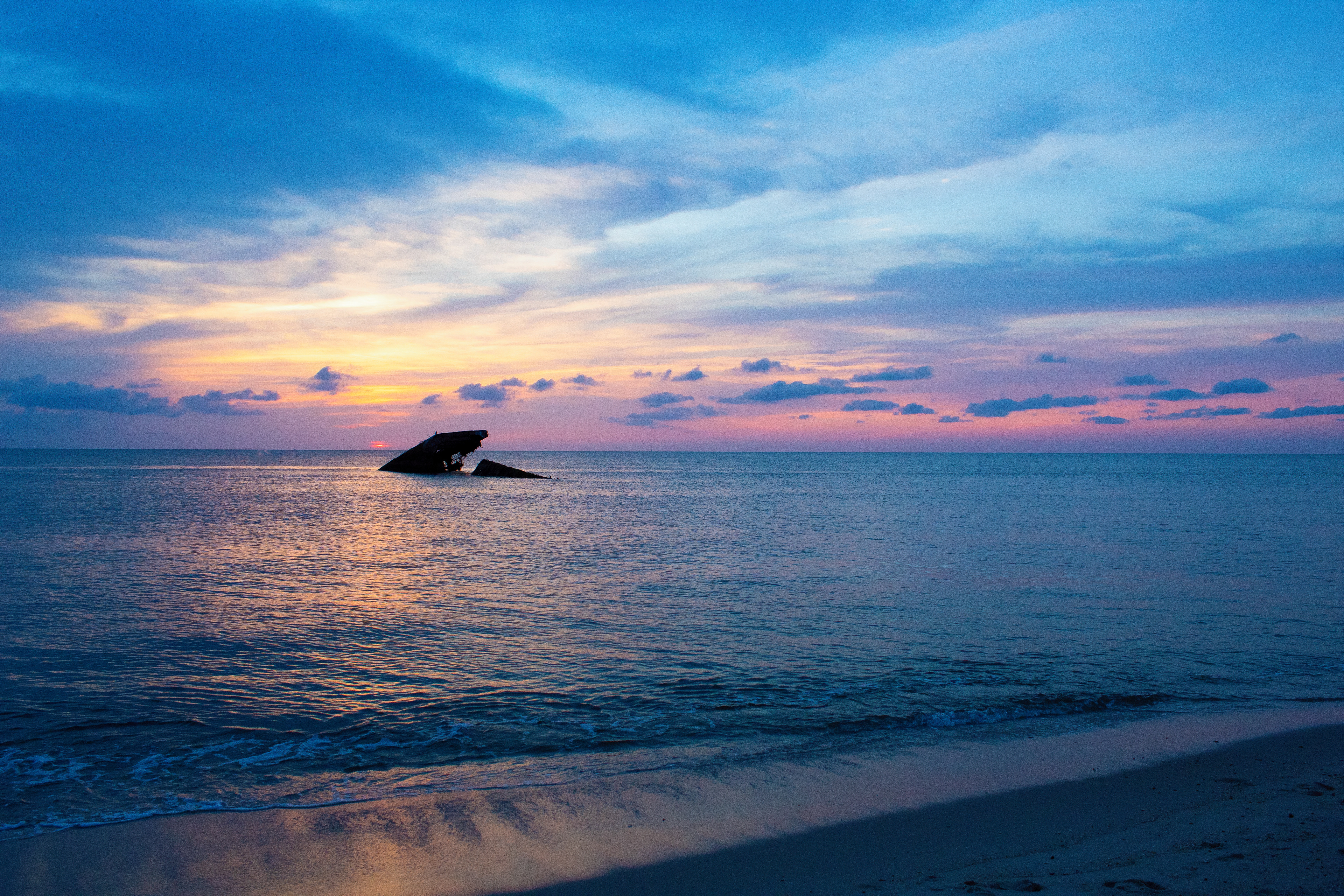 The sun sets on a shipwreck in New Jersey for the... well I have no idea how many times it has been