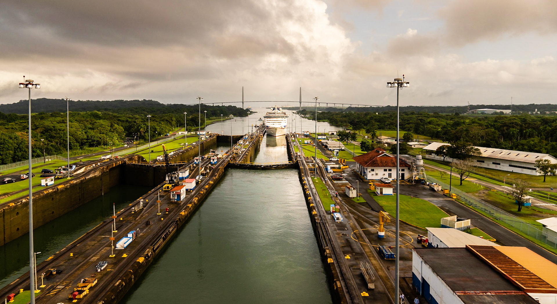 Cruise ship entering the first lock from the Atlantic side of the canal. View of the Atlantic Bridge in the background.