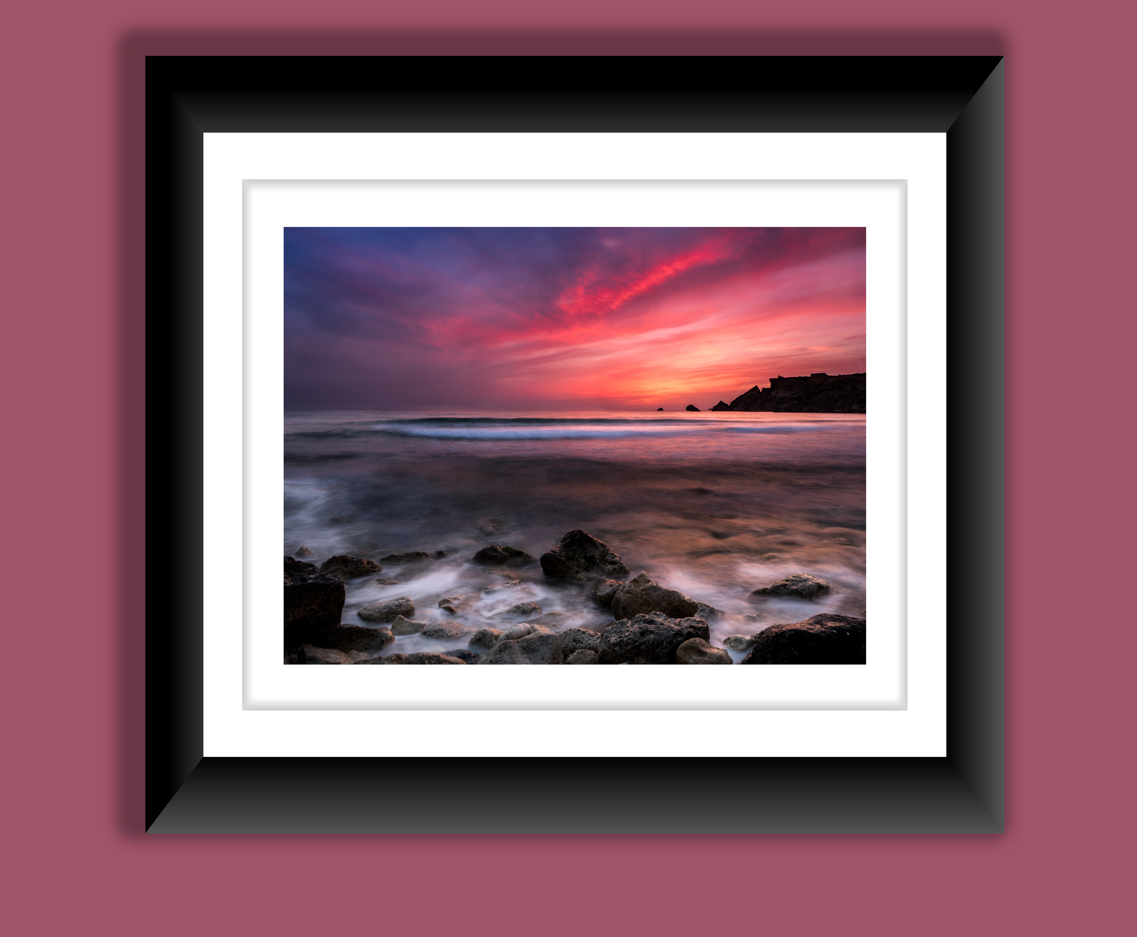 A beautiful fine art print of a vibrant, beautiful sunset at one of Maltas mosts popular beaches, Golden bay.