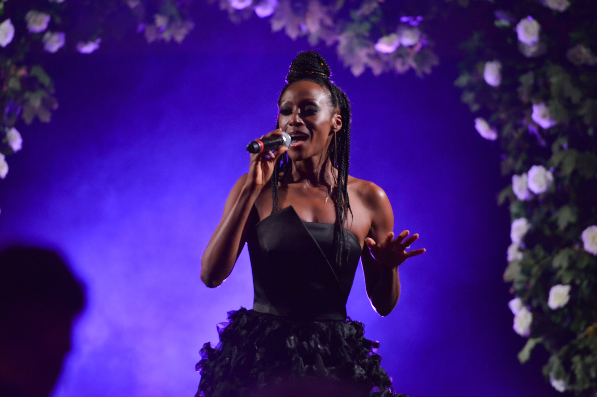 Victoria Ekanoye singing on stage at the 2019 Manchester Fashion Festival - Runway Photographer