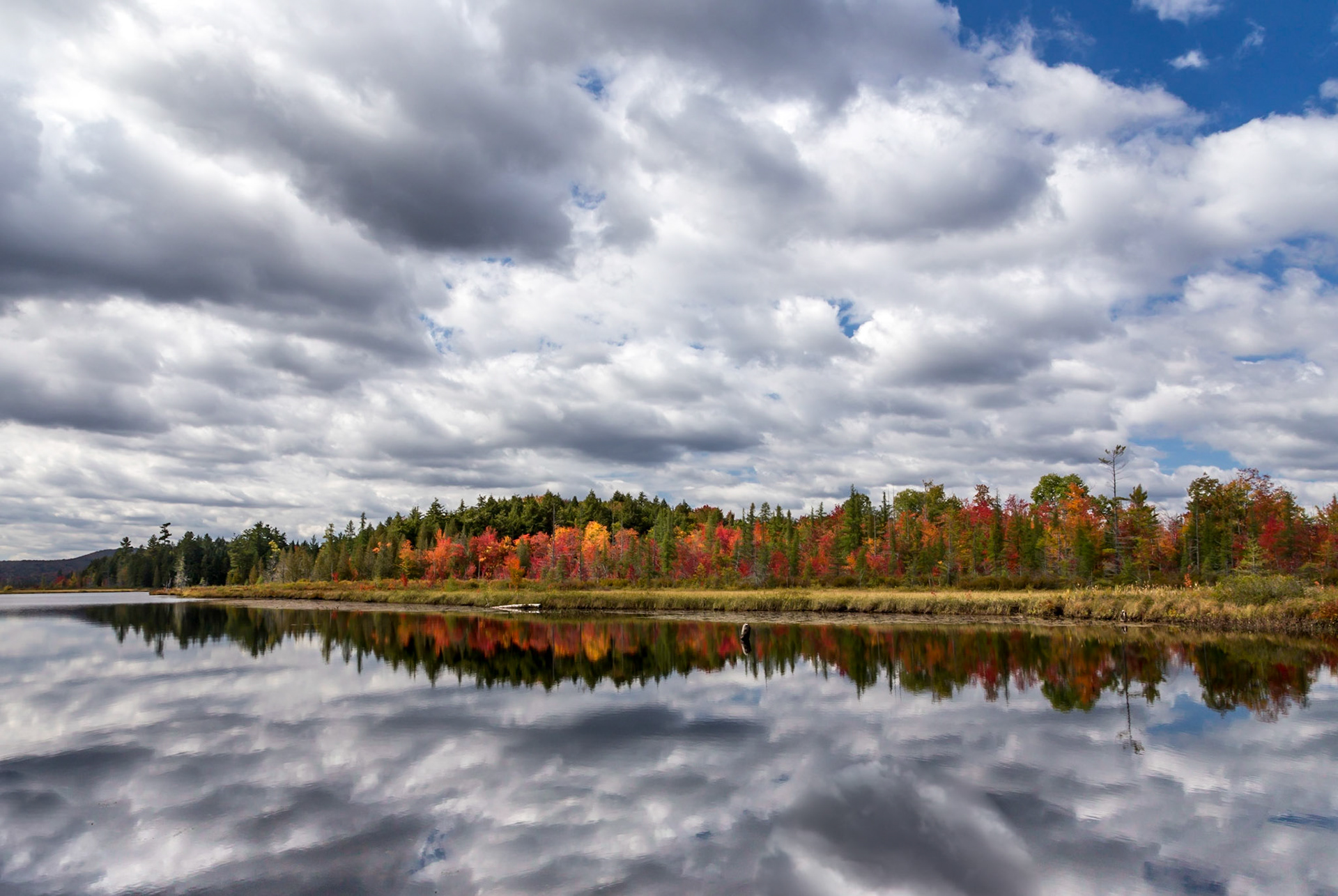 Raquette Lake Fall foliage with clouds reflected in the water