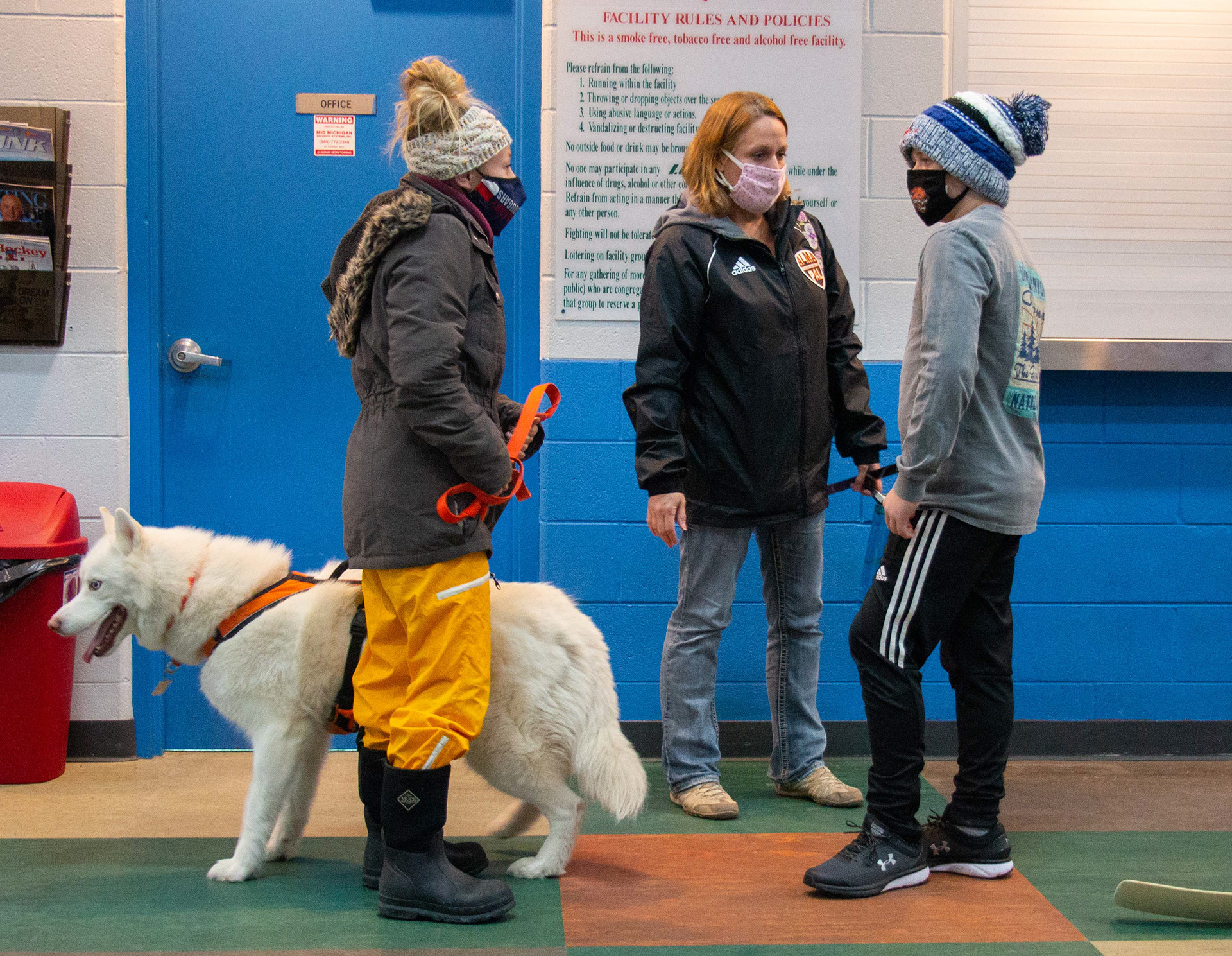Britney Knopp, left, talks to Mandy Cohoon, right, and her son Caleb Cahoon about how hockey will look like at the ice rink this year in Mt. Pleasant, Michigan on October 27, 2020. Knopp has been working at the ice rink for the last several years and has developed relationships with many hockey families.