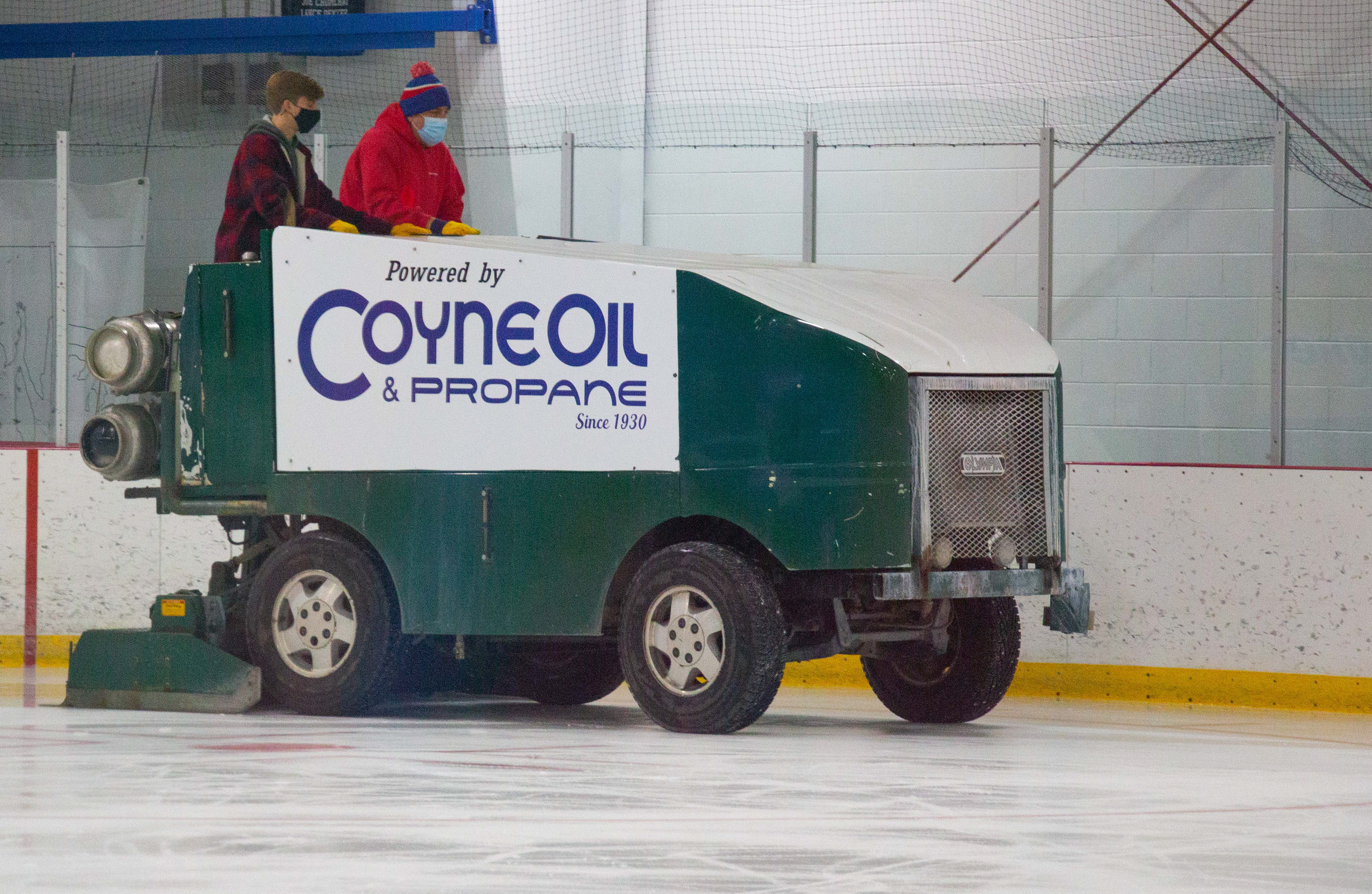 Ken Hisey, red sweatshirt, shows Dylan Bray, plaid shirt, how to cut the ice and drive the zamboni on October 27, 2020. After each skate, Hisey has to zam the ice for the next group and at the end of each night.