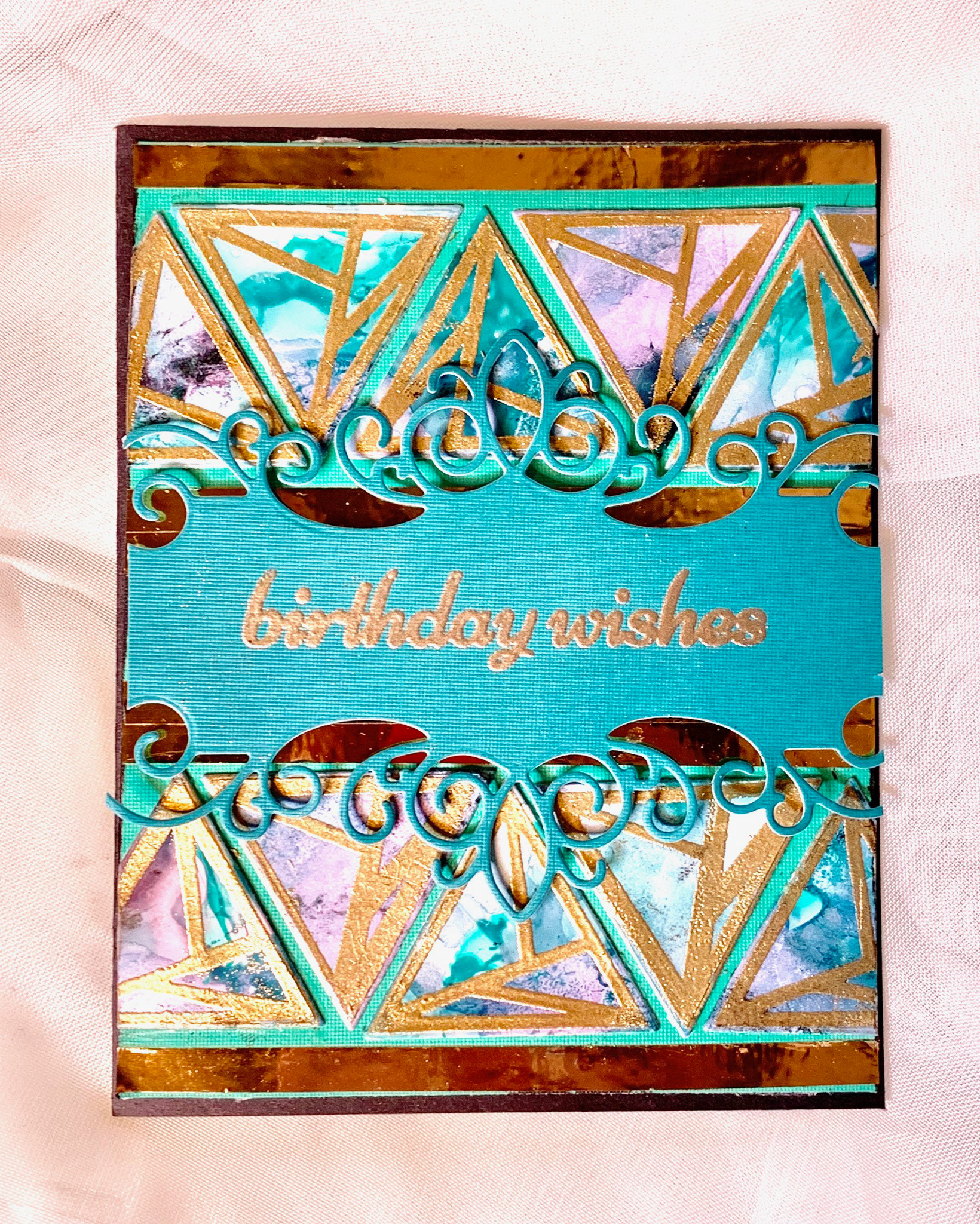 Triangles were created with Alcohol Ink background with Gold Vinyl Die Cut, border die cut and embossed sentiment/