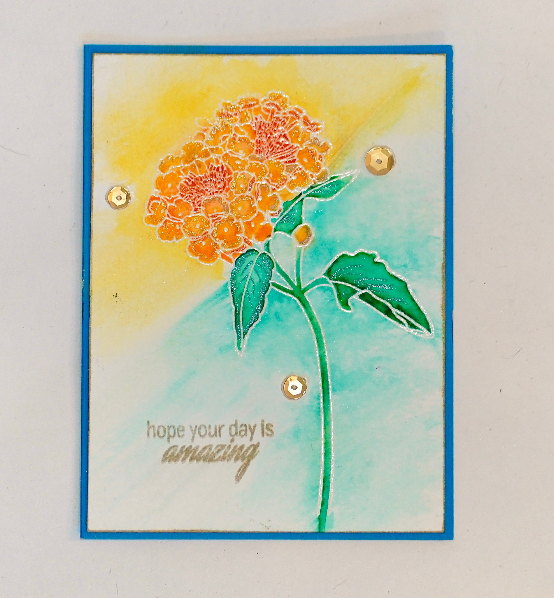 Hand Stamped Flower with heat embossing and watercolors. 