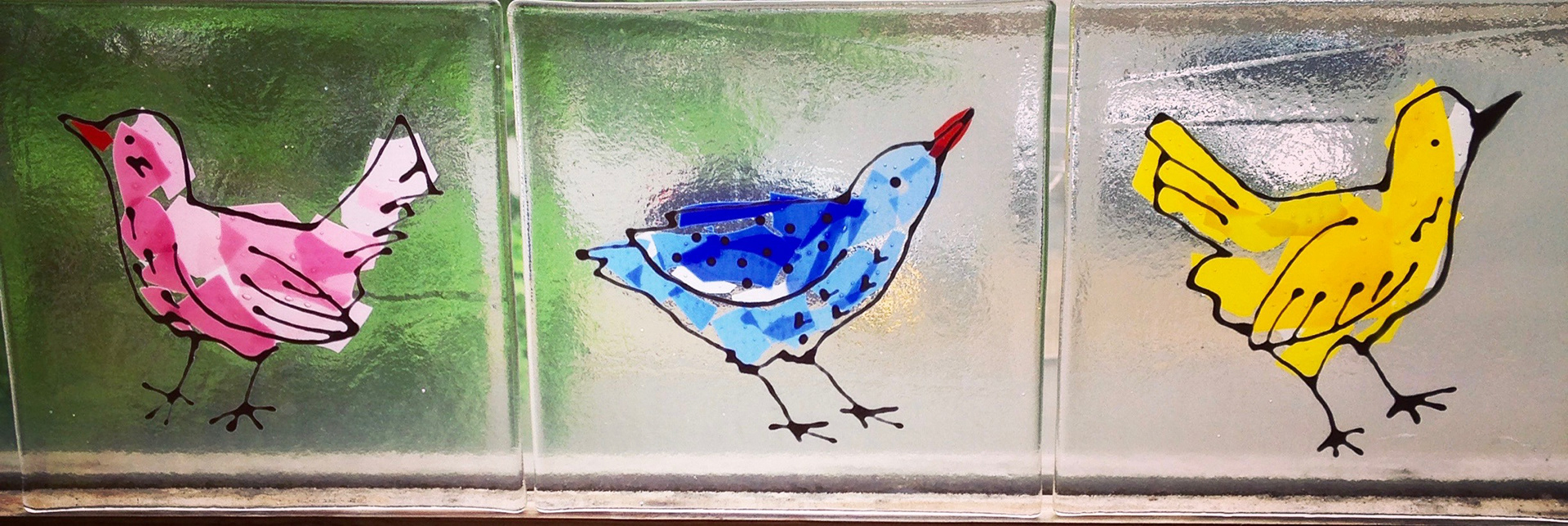 Fused and stained glass birds tiles. Kiln fired. Made by Zoe Eady at the Glass Garden. Pink, blue, yellow