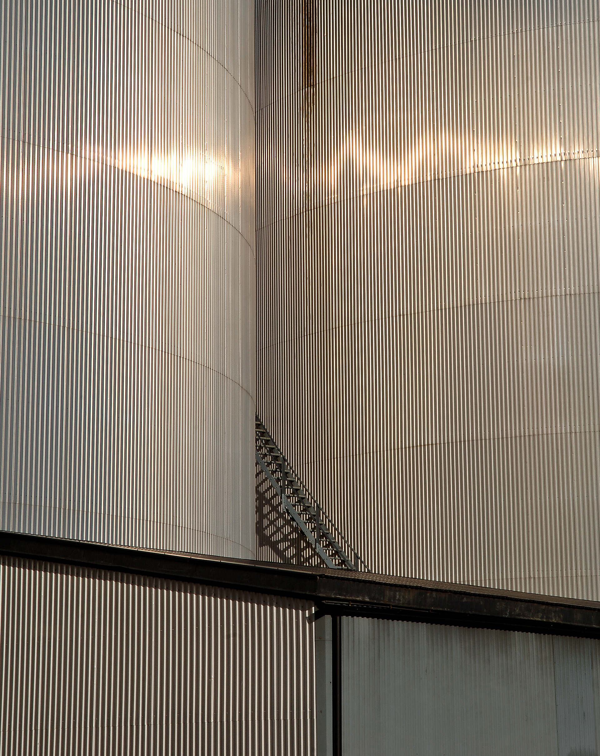 Abstact image of metal corrigated walls with stairs in the middle