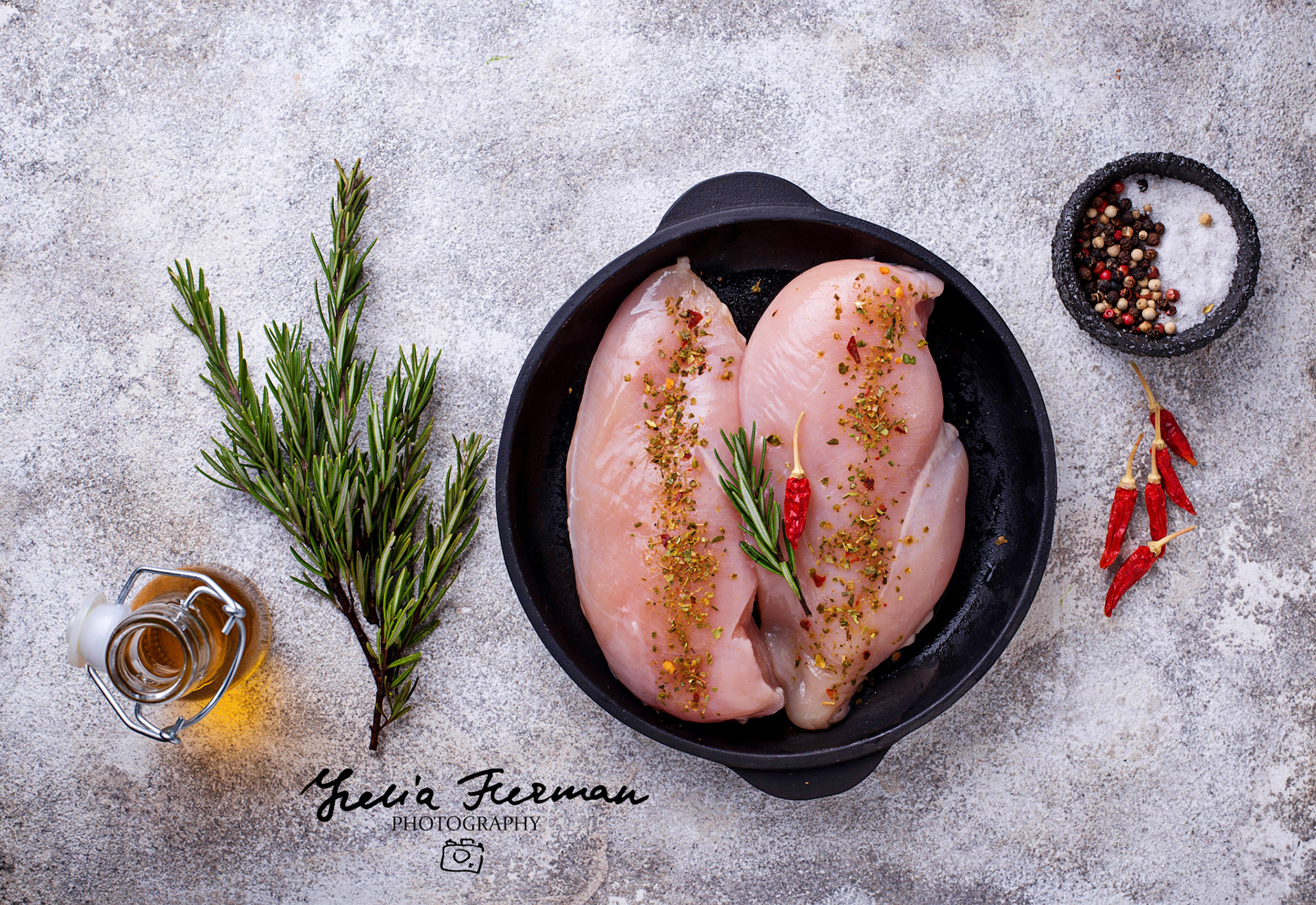 Raw chicken fillet in cast iron pan. Top view
