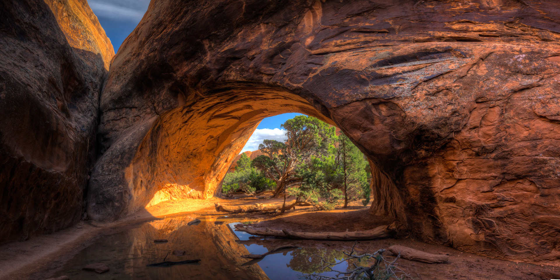 Navajo Arch after some spring storms.Arches National Park20 May 2015This is an HDR panoramic image consisting of 6 frames comprised of 5 exposures each. HDR processing performed in Photomatix Pro.  Panoramic stitching performed in Photoshop. Additional processing performed in Lightroom and Photoshop.PENTAX K-3, Sigma 10-20mm f/4-5.6 EX DCISO 100 14 mm  0.4 sec at ƒ / 11