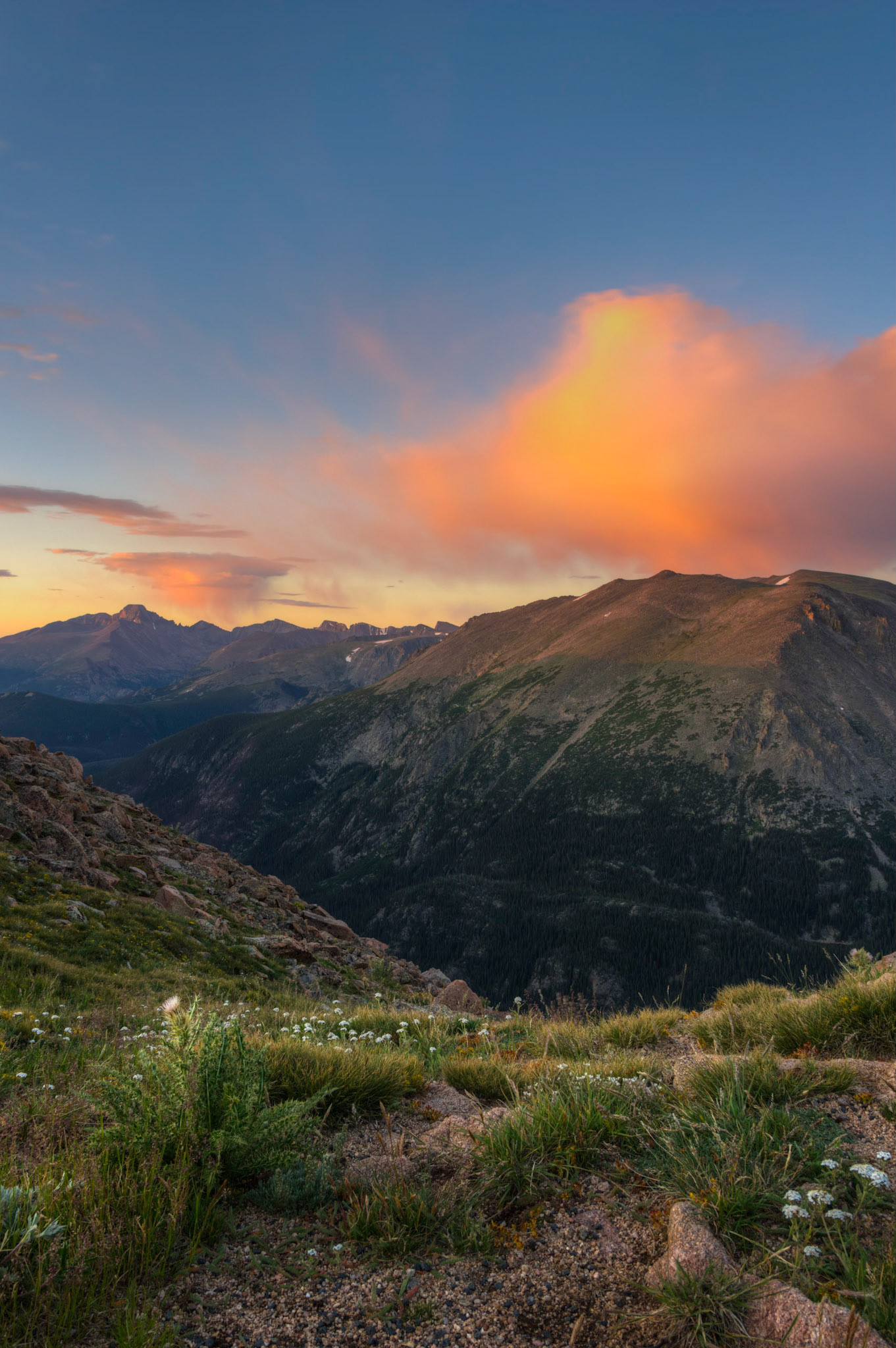 The rising sun set the clouds aglow above Stones Peak (right) and Longs Peak (left).  This photo was taken from the Forest Canyon overlook on Trail Ridge Road.Rocky Mountain National Park8 August 2014This is an HDR image consisting of 5 exposures merged in Photomatix Pro. Additional processing in Lightroom and Photoshop.PENTAX K-3, Sigma 18-250mm f/3.5-6.3 DC OS HSMISO 100 18 mm  ⅕ sec at ƒ / 11Prints of my work are available from my website at http://www.fingolfinphoto.comFollow me on Facebook at http://www.facebook.com/fingolfinphoto or http://www.facebook.com/pesterleAlso, http://500px.com/pesterle   http://www.flickr.com/photos/fingolfinphoto