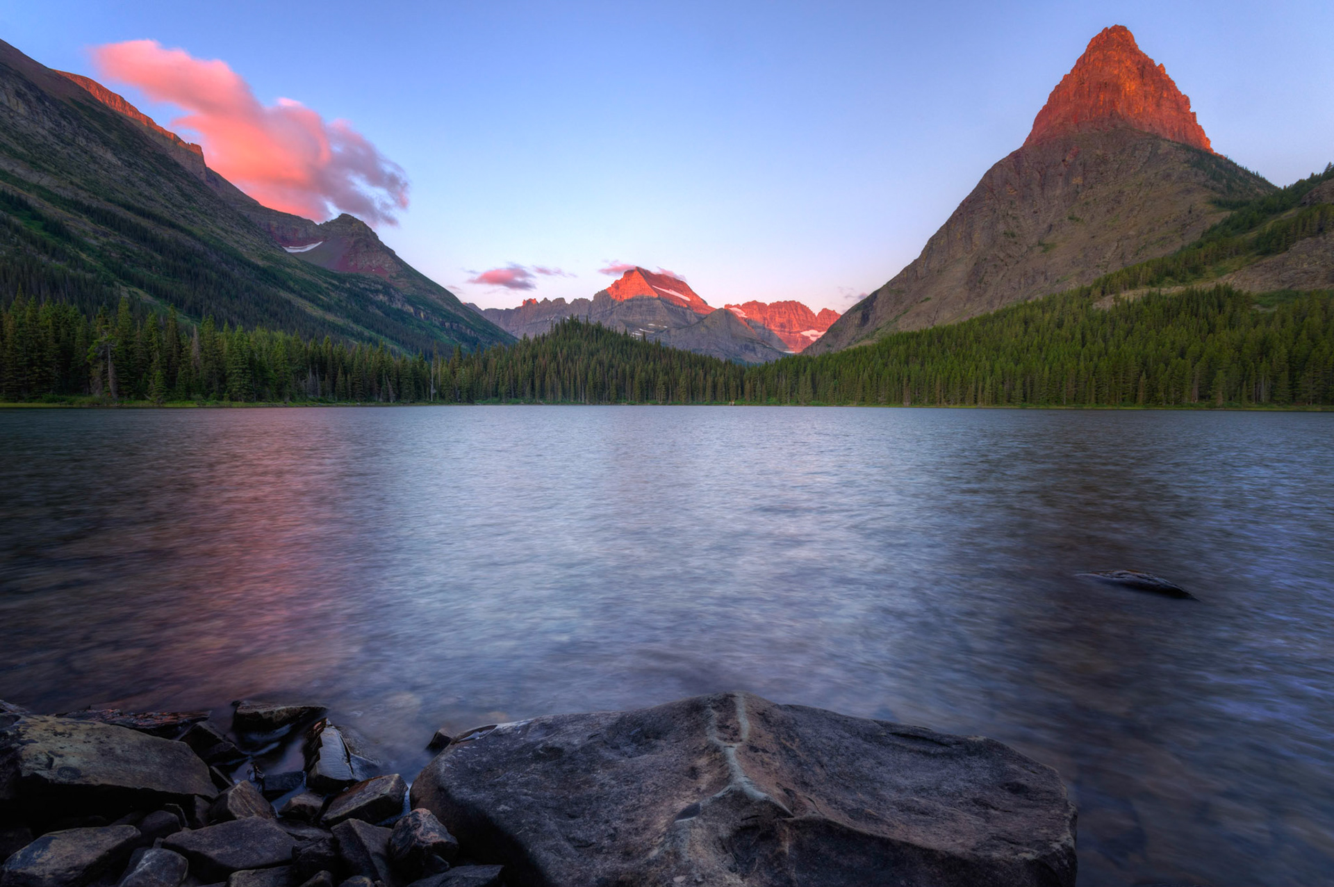Alpenglow on Grinnell Point and the surrounding mountains, from the shore of Swiftcurrent Lake.Glacier National ParkJuly 29, 2015This is an HDR image consisting of 5 exposures merged in Photomatix Pro. Additional processing in Lightroom and Photoshop.PENTAX K-3, Sigma 10-20mm f/4-5.6 EX DCISO 100 10 mm  0.5 sec at ƒ / 11