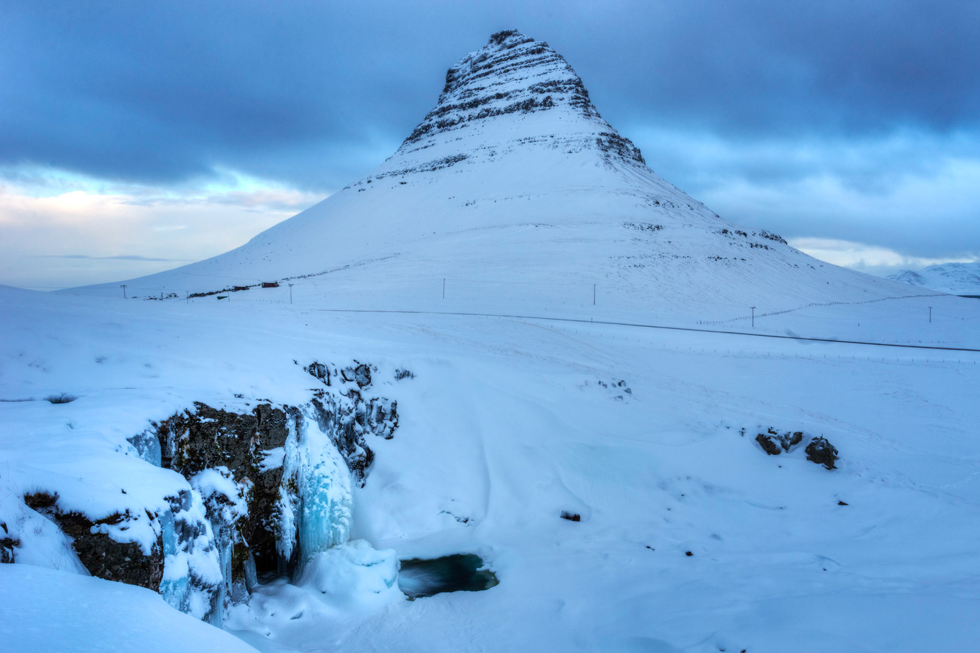 Iconic Kirkjufell and Kirkjufellfoss, on the Snæfellsness Peninsula in west Iceland.Grundarfjörður, Vestrulund, IcelandFebruary 6, 2016This is an HDR image consisting of 5 exposures merged in Photomatix Pro. Additional processing in Lightroom and Photoshop.PENTAX K-3, Sigma 18-35mm f/1.8 DC HSM ArtISO 100 18 mm  1.3 sec at ƒ / 16