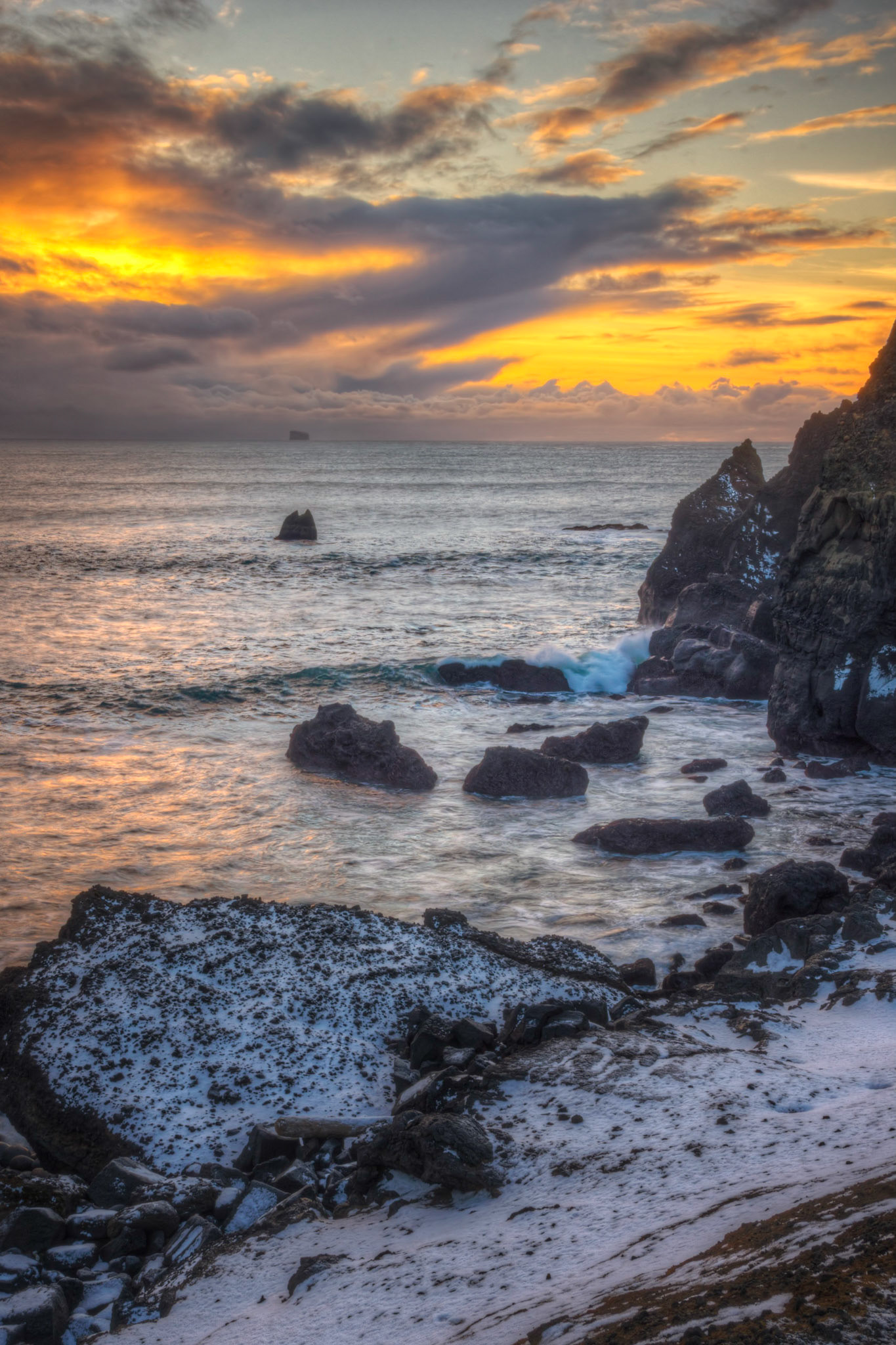 Sunset at the western end of Reykjanes.  In the distance is the island of Eldey, about 10 miles off the coast.  It is the home of about 16000 pairs of northern gannets.Suðernes, IcelandFebruary 12, 2016This is an HDR image consisting of 5 exposures merged in Photomatix Pro. Additional processing in Lightroom and Photoshop.PENTAX K-3, Sigma 18-250mm f/3.5-6.3 DC OS HSMISO 100 28 mm  ¹⁄₂₅ sec at ƒ / 18