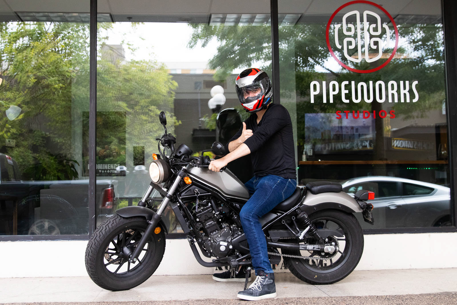 Employee of Pipeworks Studios posing in front of downtown Eugene office