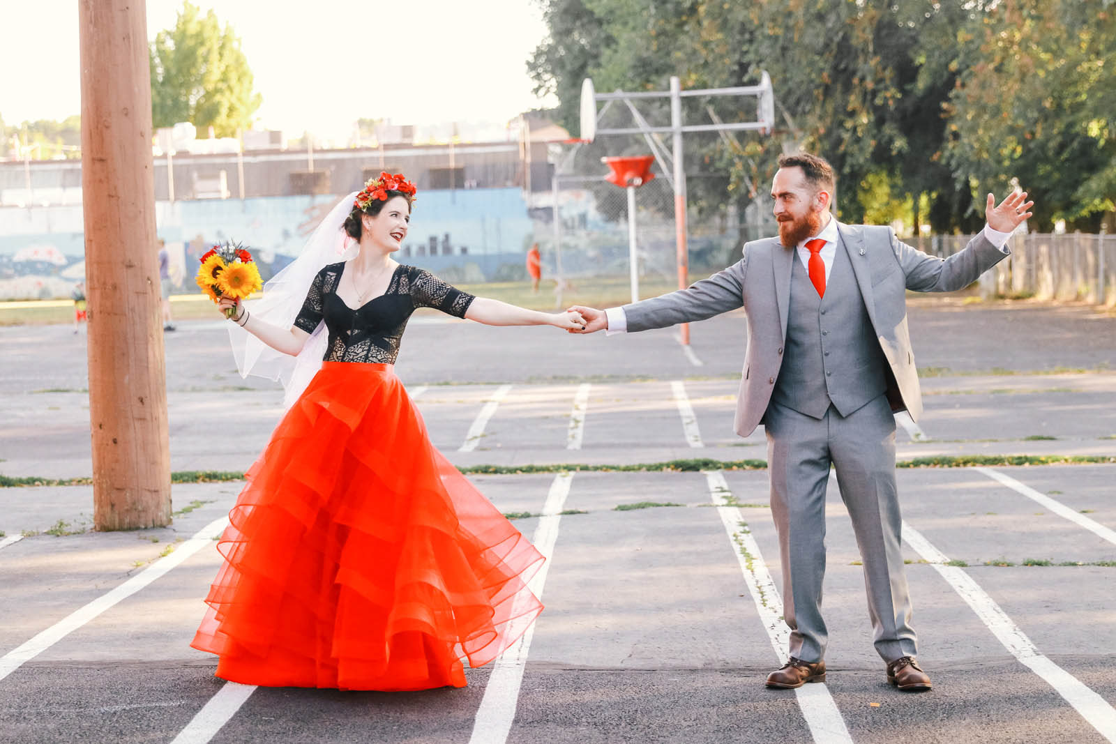 Bride and groom holding hands after ceremony, bright bold red color