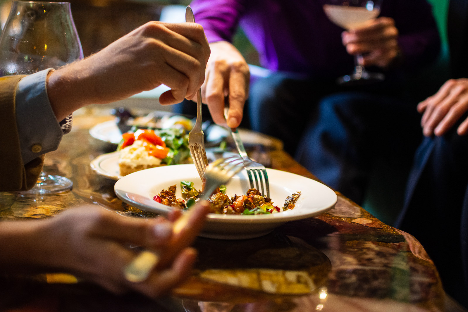 Group of friends eating from shared plates