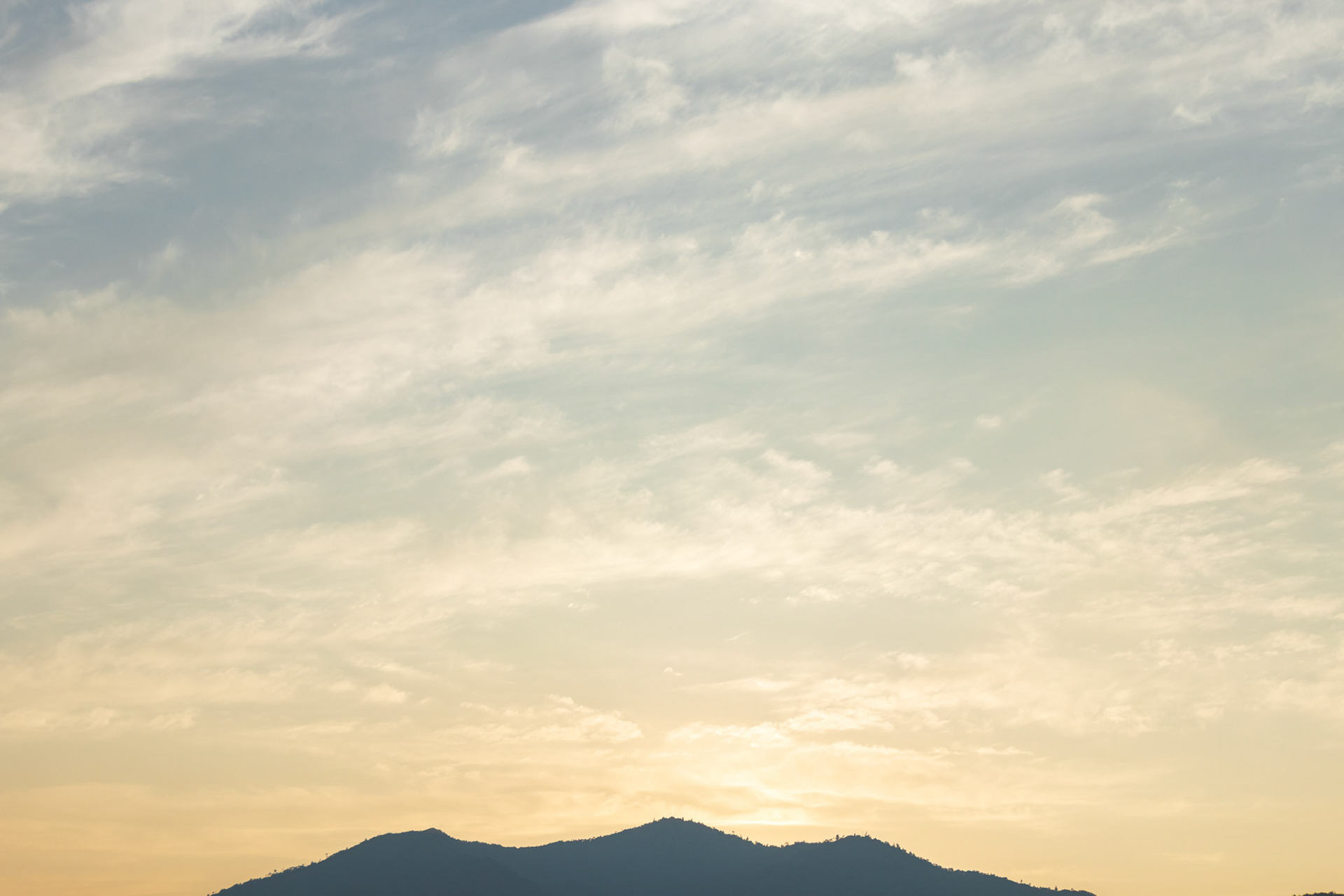Twilight sky and mountains. Sunlight and wind create breathtaking shapes and colors. This image was taken in June 2018, Hiroshima, Japan.