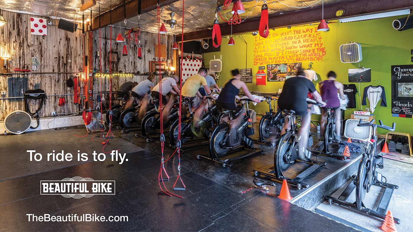 Advertisment for a cycle studio with athletes riding stationary bikes