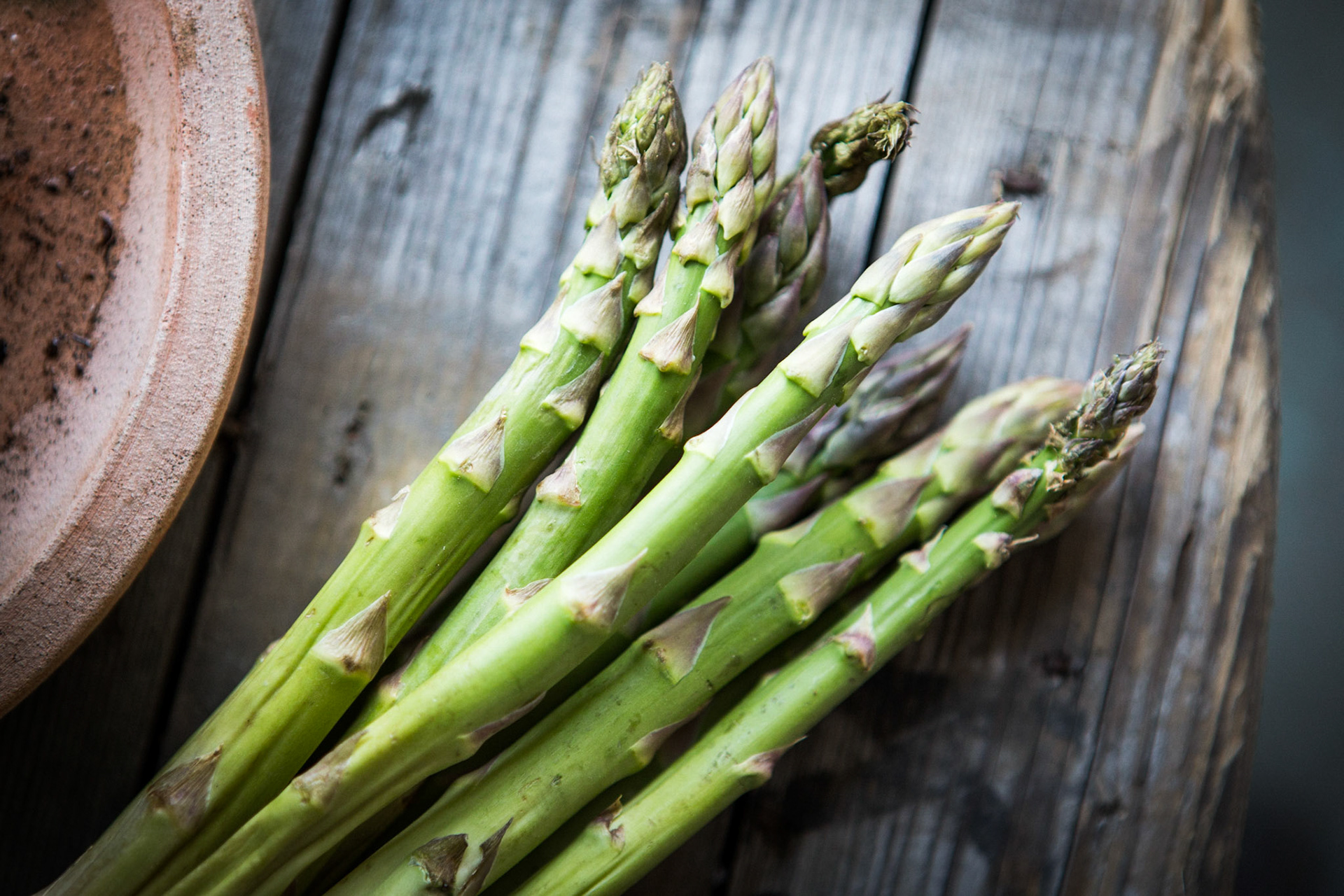 Bunch of fresh asparagus on a dark background